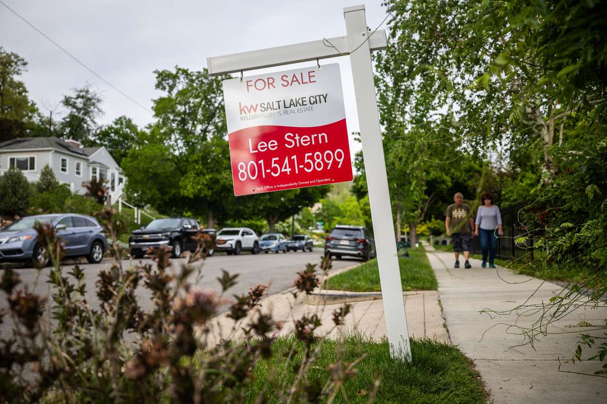 A for-sale sign is posted outside a house in the Avenues neighborhood in Salt Lake City on May 23. Mortgage rates and housing prices are slowly dropping, but homebuyers are still hesitant, Redfin real estate agent Katie Shook said Wednesday.