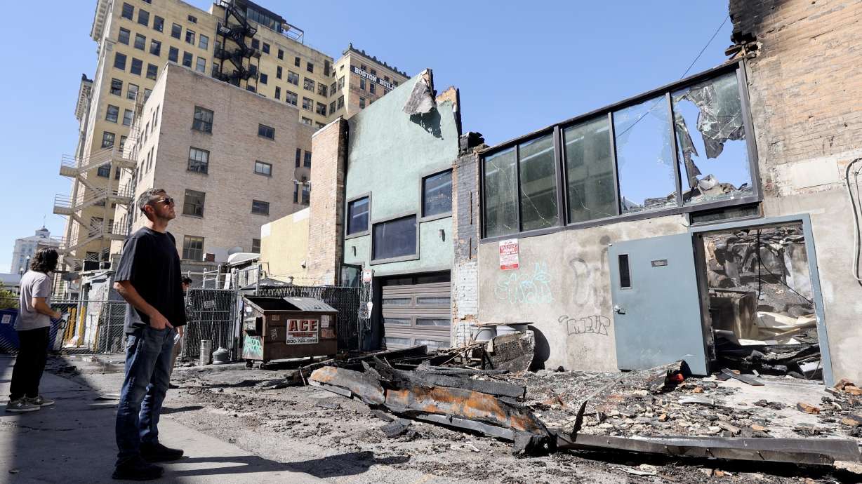 Christian Priskos, co-owner of Whiskey Street and White Horse, looks at the scene of a structure fire that destroyed four businesses on the 300 South block of Main Street in downtown Salt Lake City on Tuesday.