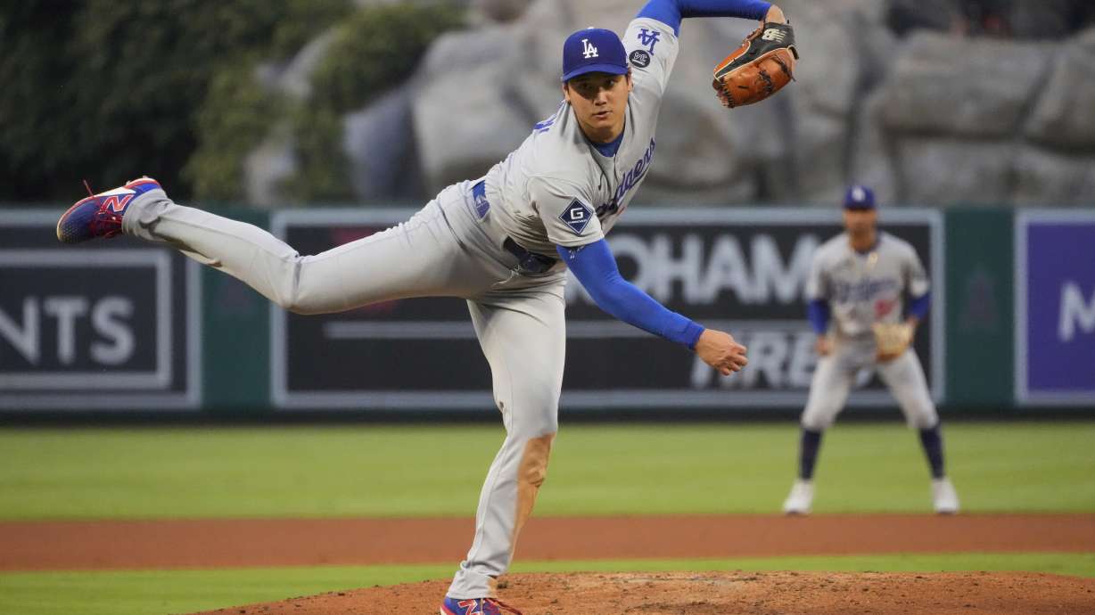 Los Angeles Dodgers starting pitcher Shohei Ohtani throws to the plate during the third inning of a baseball game against the Los Angeles Angels, Wednesday, Aug. 13, 2025, in Anaheim, Calif.