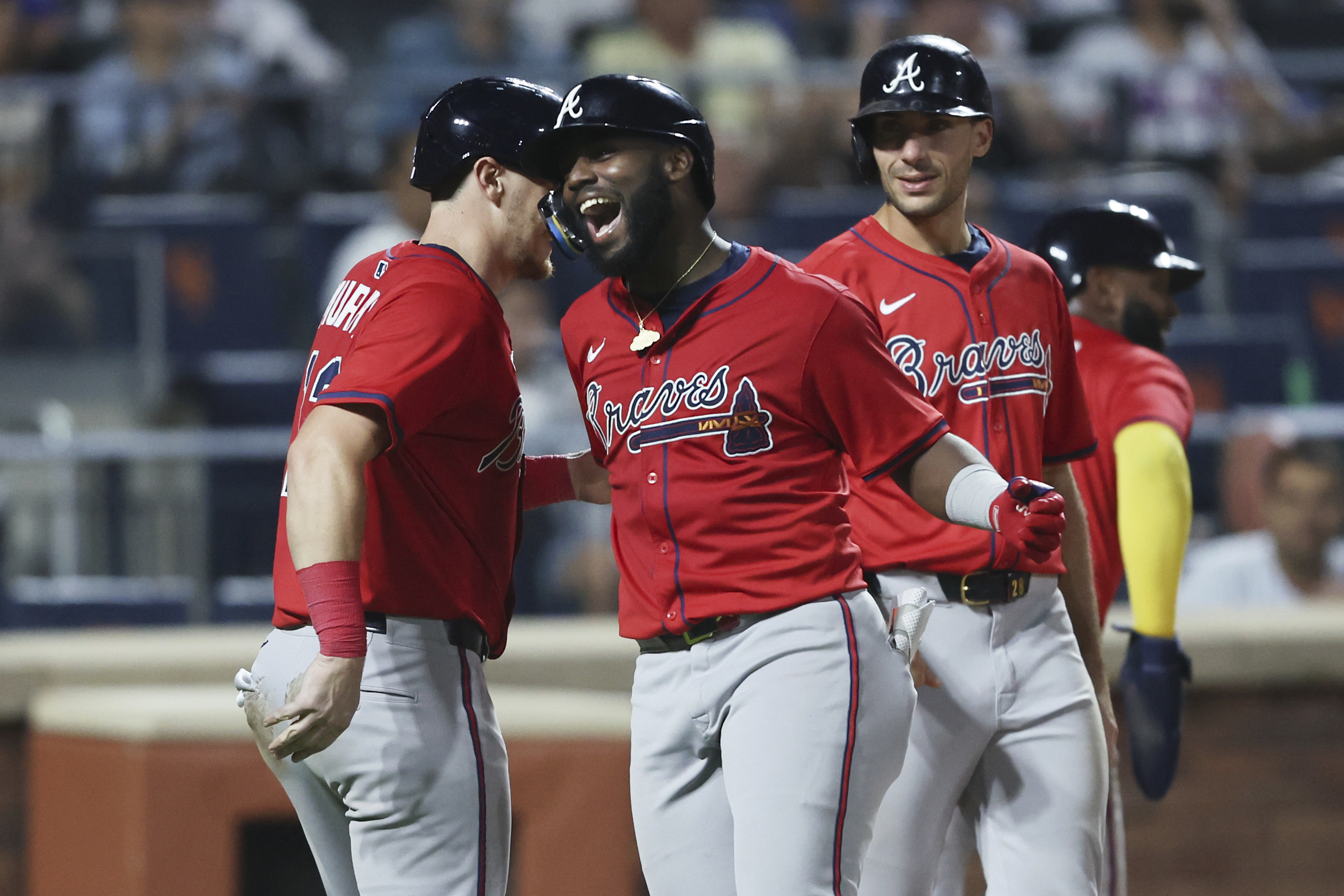 Atlanta Braves' Michael Harris II, center, celebrates his grand slam during the fourth inning of a baseball game against the New York Mets, Wednesday, Aug. 13, 2025, in New York.