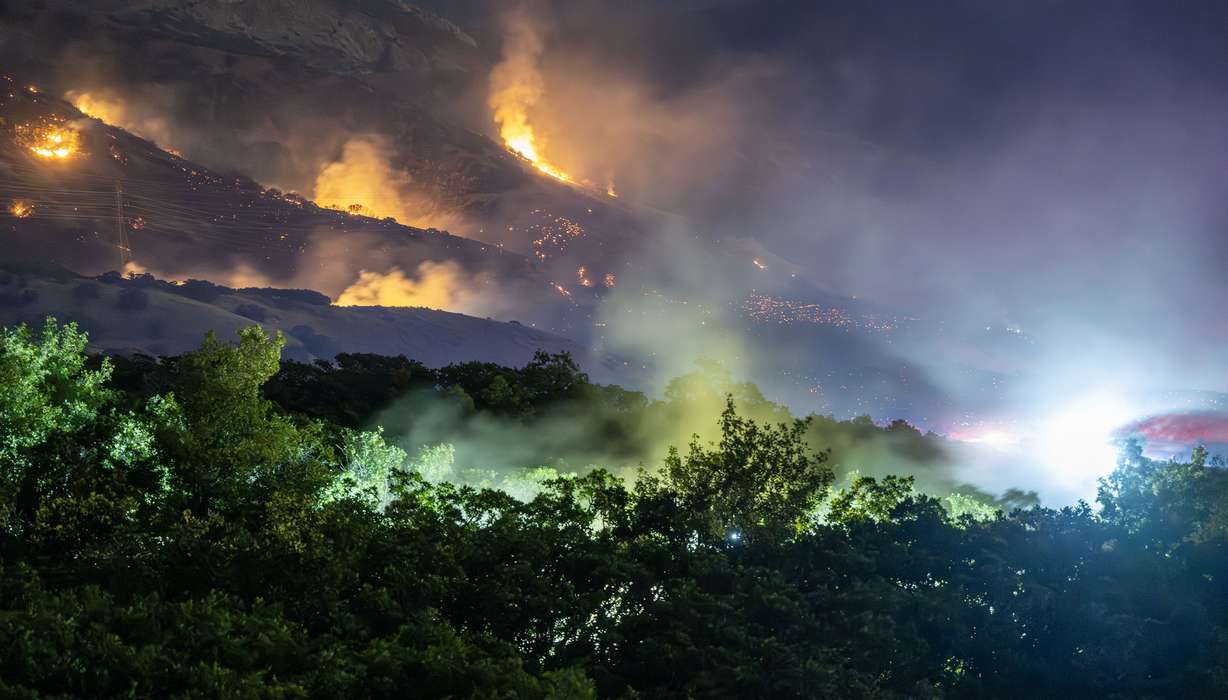 The Willard Peak Fire burns near homes and on the mountain in North Ogden on Wednesday. It continued to burn Thursday and had covered 754 acres.