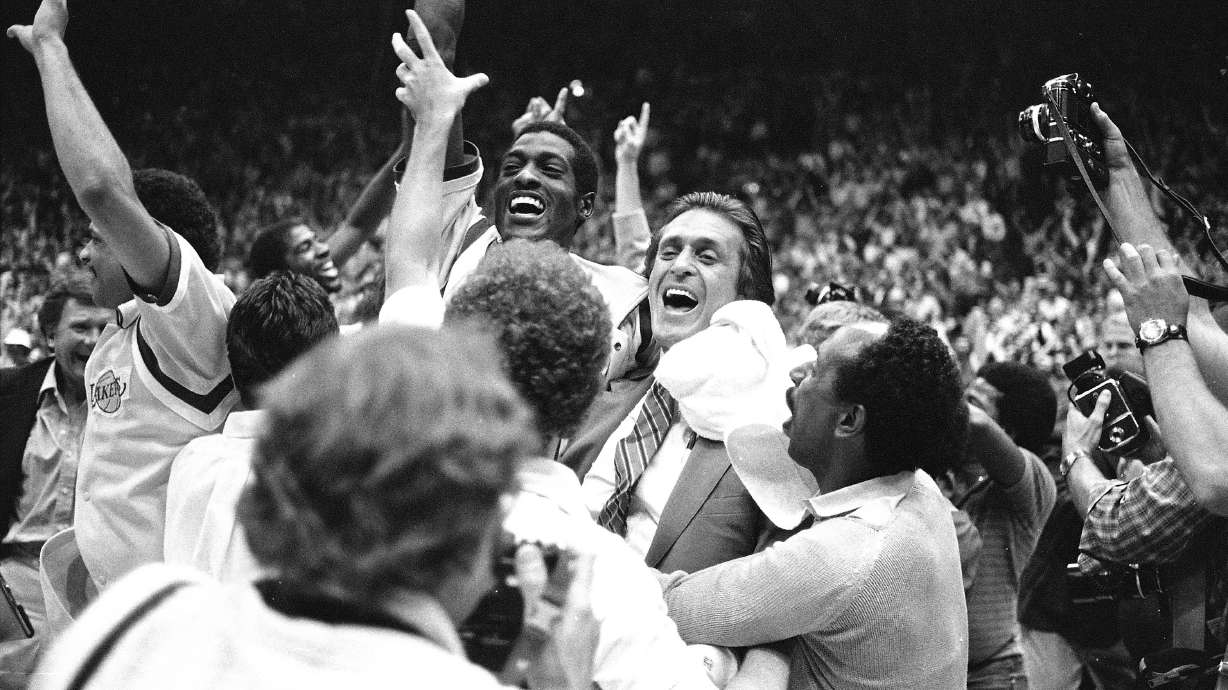 FILE - Los Angeles Lakers head coach Pat Riley, center right, is swamped by fans and players after the Lakers defeated the Philadelphia 76ers to win the NBA championship in Los Angeles, June 9, 1982.