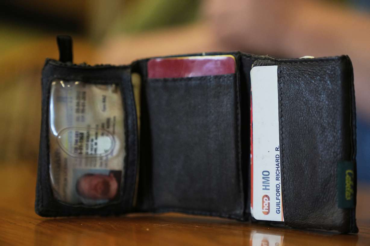 The old wallet of Richard Guilford is seen as he speaks during an interview on Thursday in Petersburg, Mich.