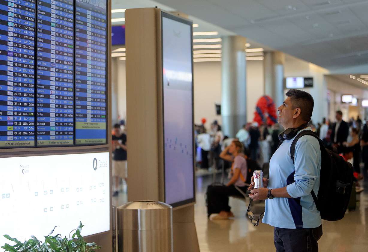 Victor Salvador looks at the departures board at the Salt Lake City International Airport on June 12. The airport was ranked as the best in the nation, according to a new report from AirHelp.