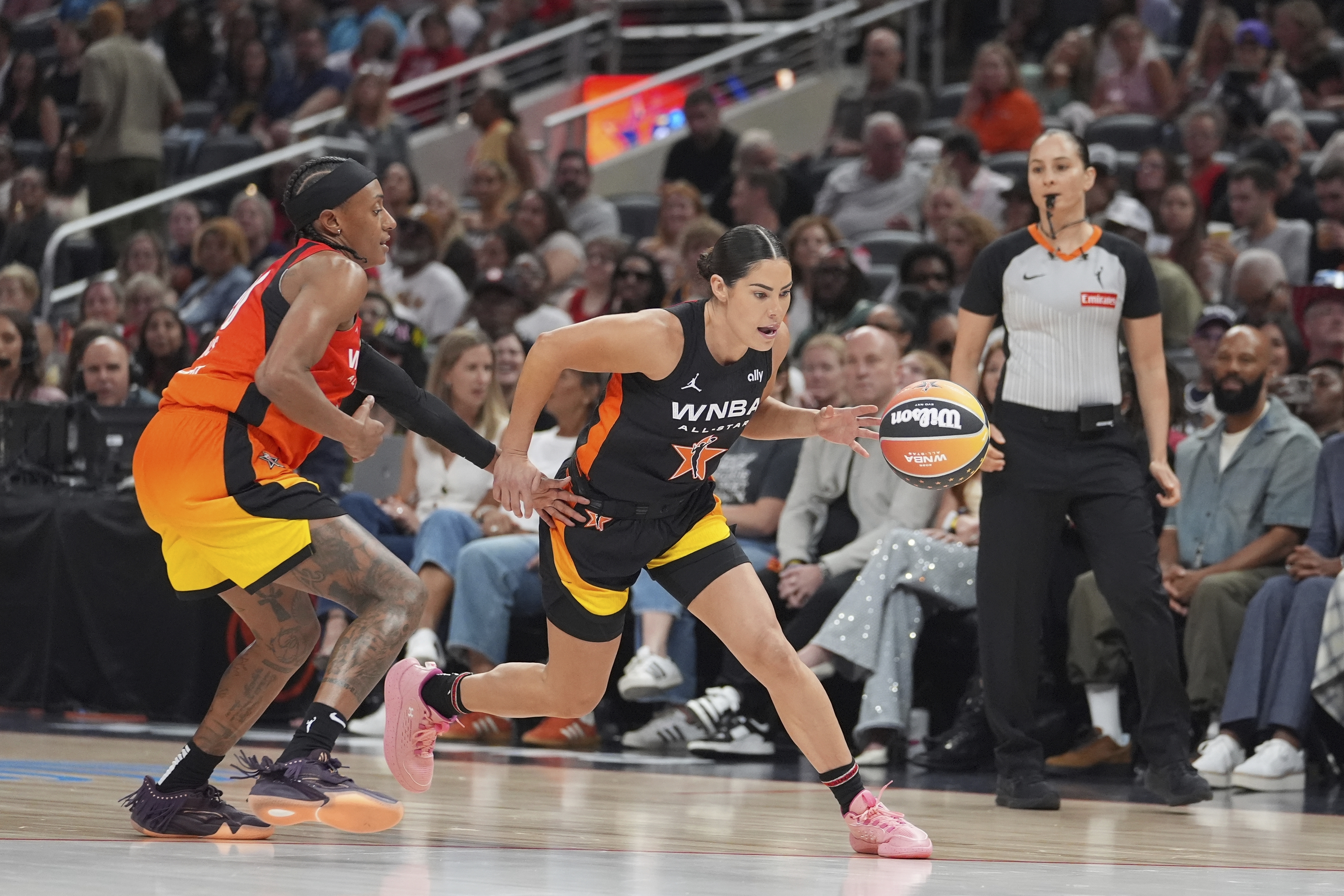 Los Angeles Sparks's Kelsey Plum, right, goes to the basket against Washington Mystics' Brittney Sykes during the second half of a WNBA All-Star basketball game, Saturday, July 19, 2025, in Indianapolis. 