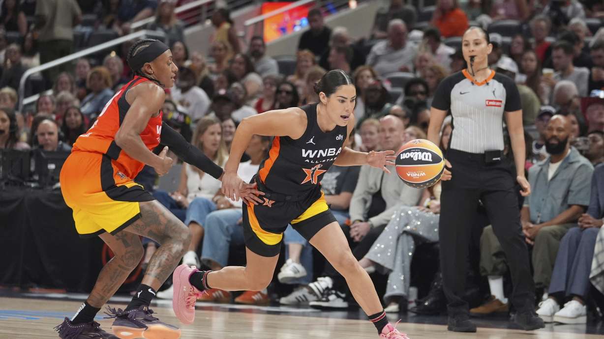 Los Angeles Sparks's Kelsey Plum, right, goes to the basket against Washington Mystics' Brittney Sykes during the second half of a WNBA All-Star basketball game, Saturday, July 19, 2025, in Indianapolis.