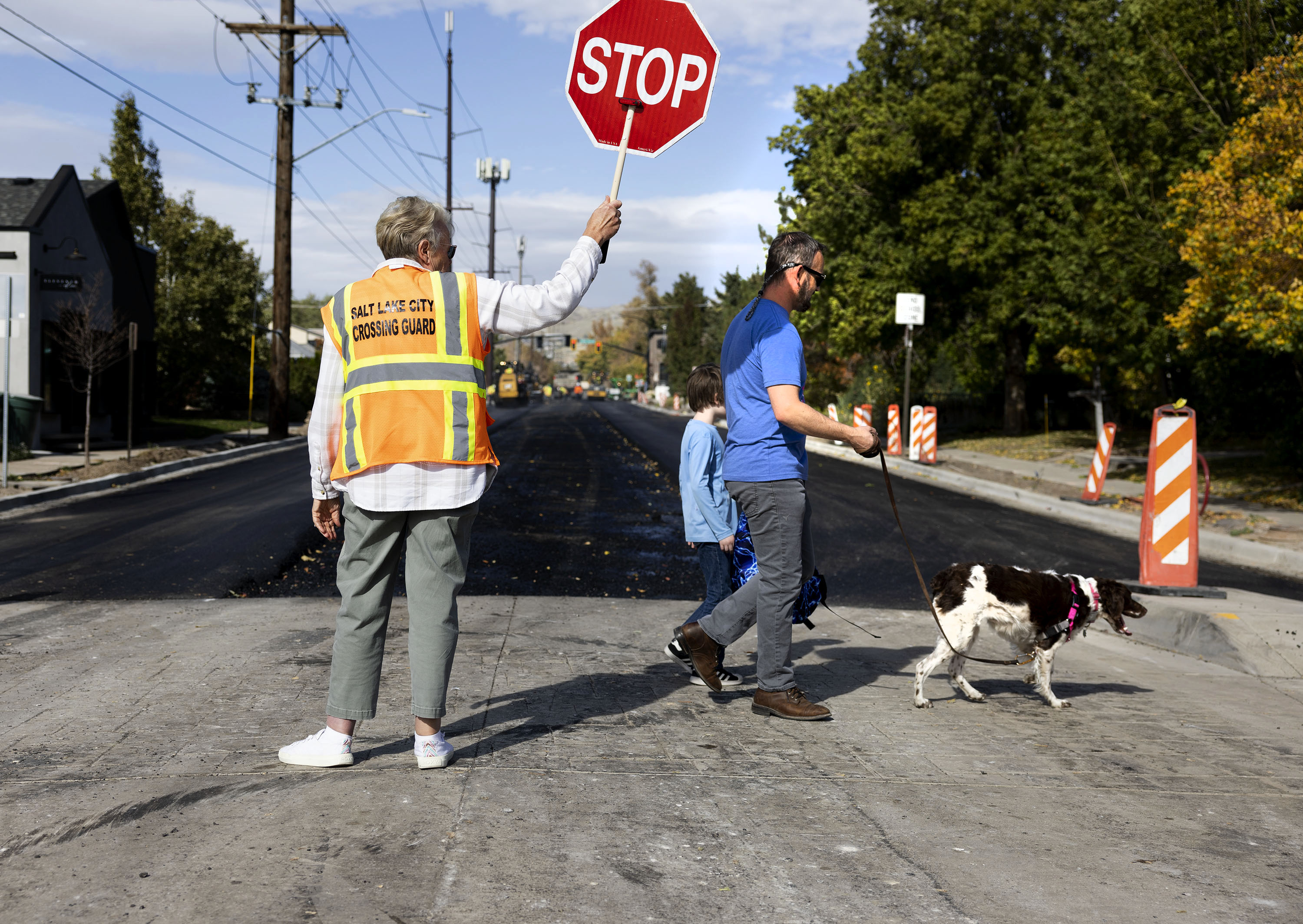 Arlee Willits helps Emerson Elementary School students and their family members cross 1100 East in Salt Lake City on Oct. 25, 2023.