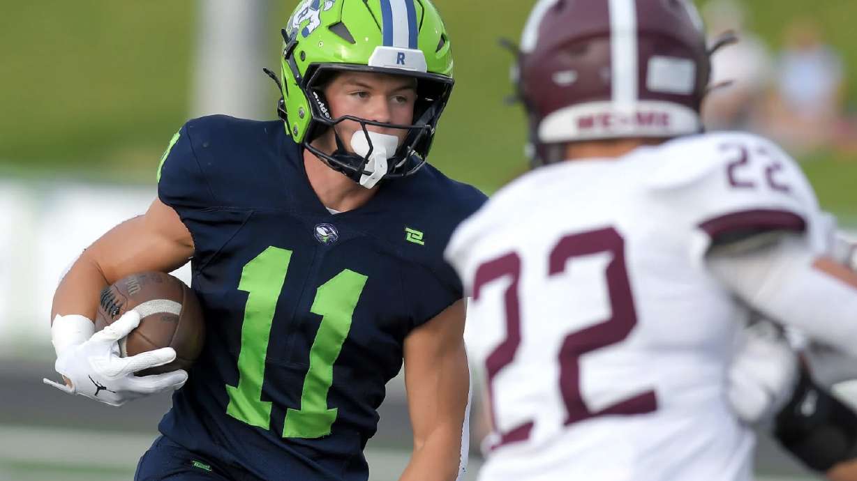 Ridgeline wide receiver Graham Livingston (11) runs down the field as Morgan’s Jake Halls defends Friday night in Millville. Livingston caught three touchdown passes in the Riverhawks 34-14 win to open the season.