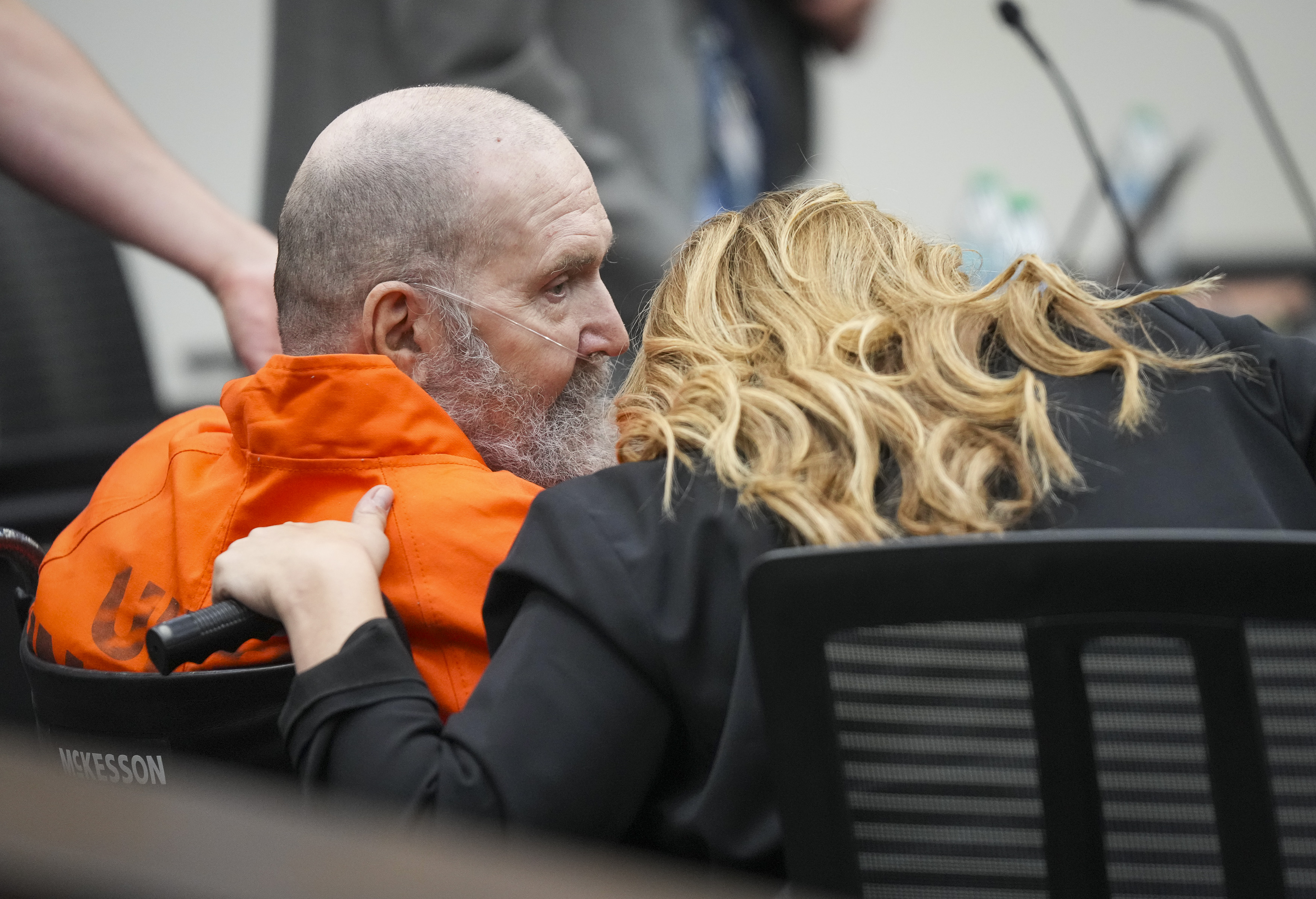 Ralph Menzies speaks with Jasmine North, federal public defender mitigation investigator, during his commutation hearing at the Utah State Correctional Facility in Salt Lake City on Aug. 15.