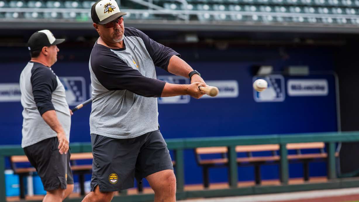 Salt Lake Bees manager Keith Johnson hits a baseball during a team practice at The Ballpark at America First Square in South Jordan on Aug. 9. Johnson was hired to