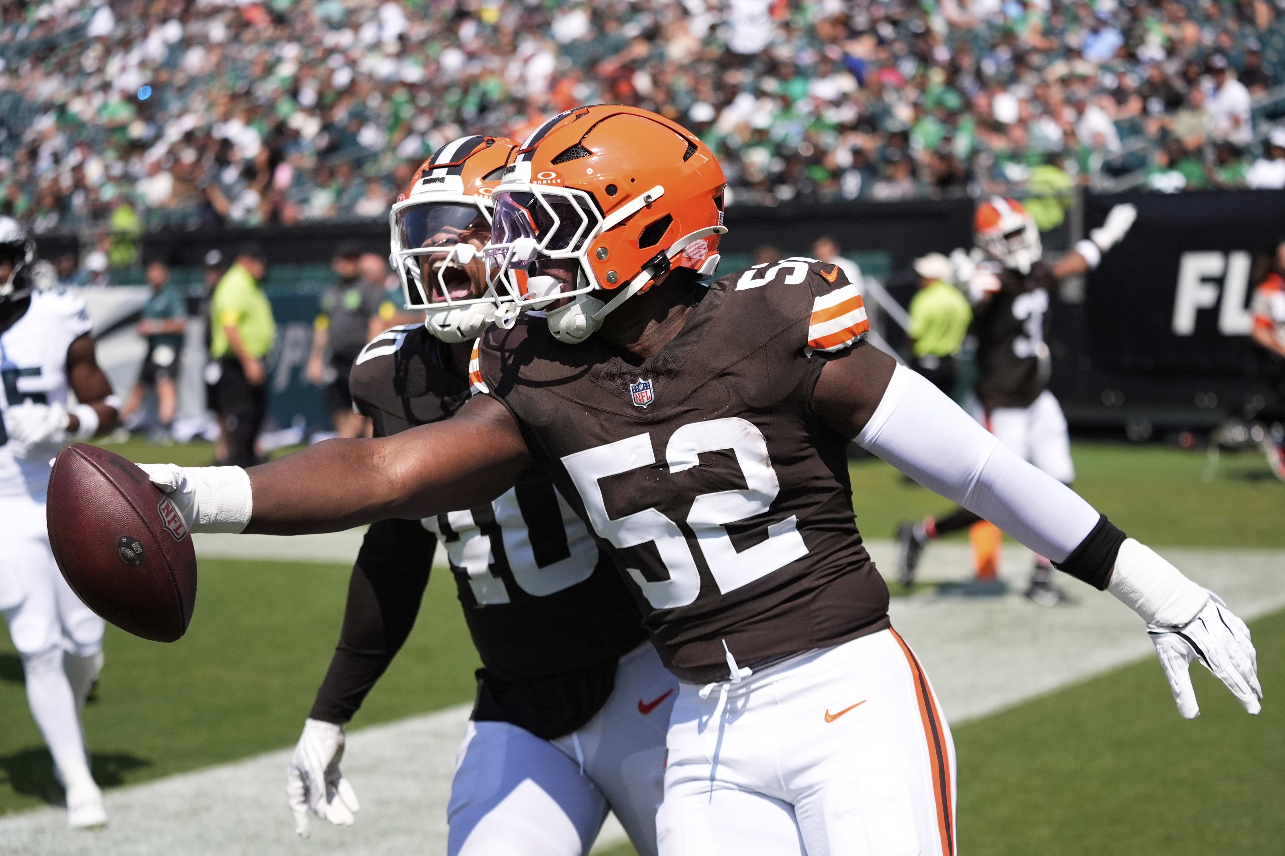 Cleveland Browns defensive end KJ Henry (52) celebrates his interception for a touchdown with Browns linebacker Nathaniel Watson (40) during the second half of an NFL preseason football game against the Philadelphia Eagles on Saturday, Aug. 16, 2025, in Philadelphia.