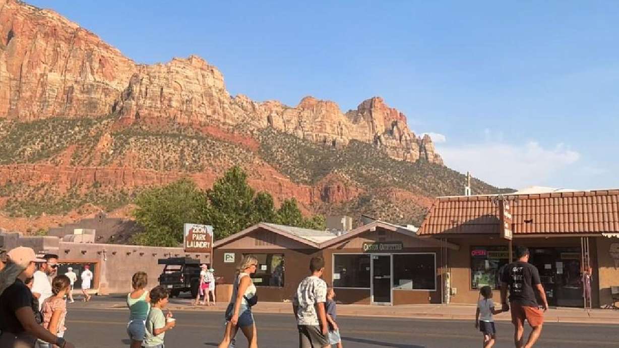 Tourists walk across state Route 9 in Springdale, July 15. A new national "Trail Map" was unveiled recently that will help leverage tourism while maintaining small-town charm, especially in Utah.