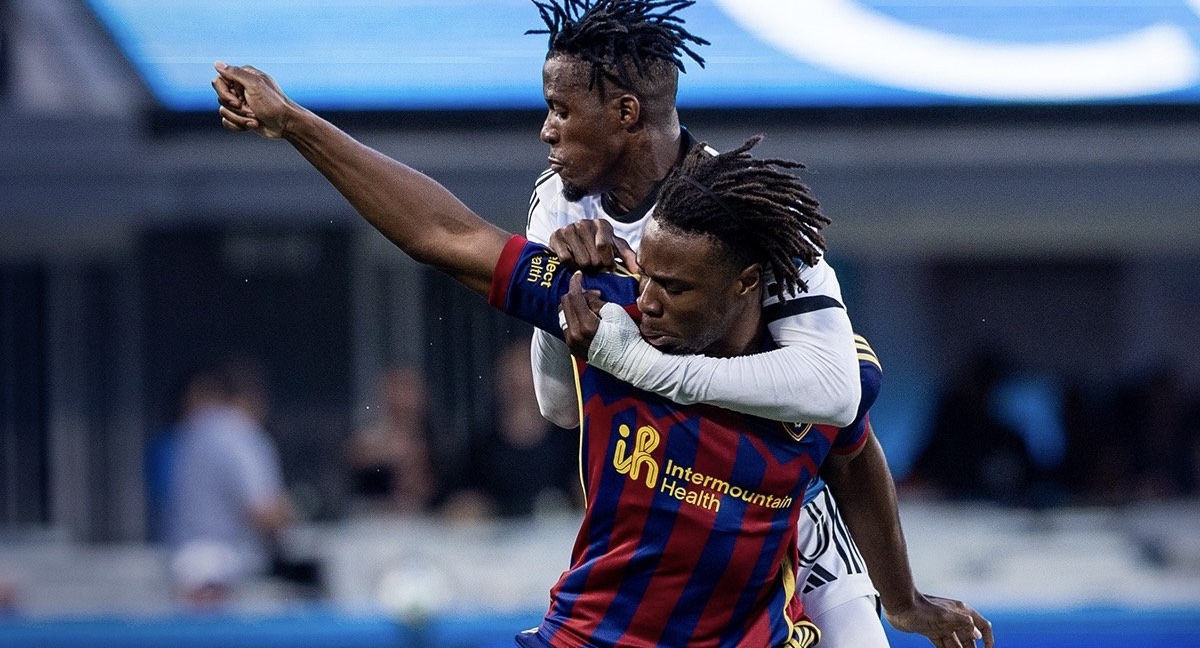 RSL's Emeka Eneli, bottom, is tackled by Charlotte's Wilfried Zaha, top.