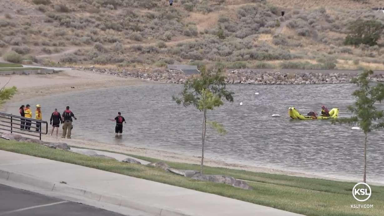 Search and rescue crews look for a swimmer who went under the water at Blackridge Reservoir in Herriman on Saturday. The man's body was located by a submersible robot later that night.