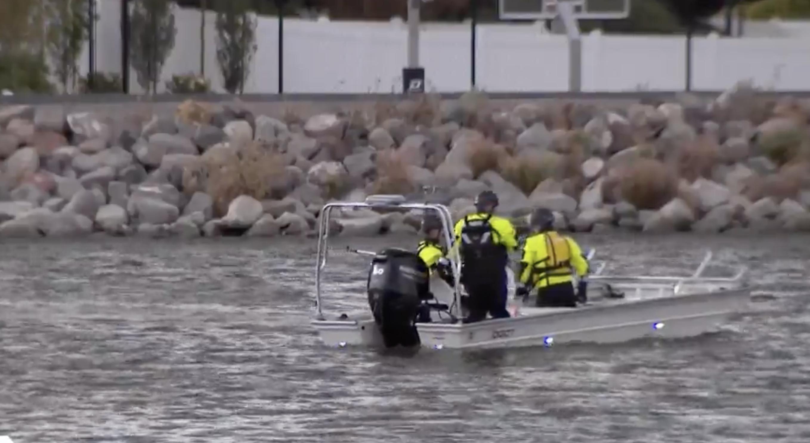Search and rescue crews look for a swimmer who went under the water at Blackridge Reservoir in Herriman on Saturday. The man's body was located by a submersible robot later that night.