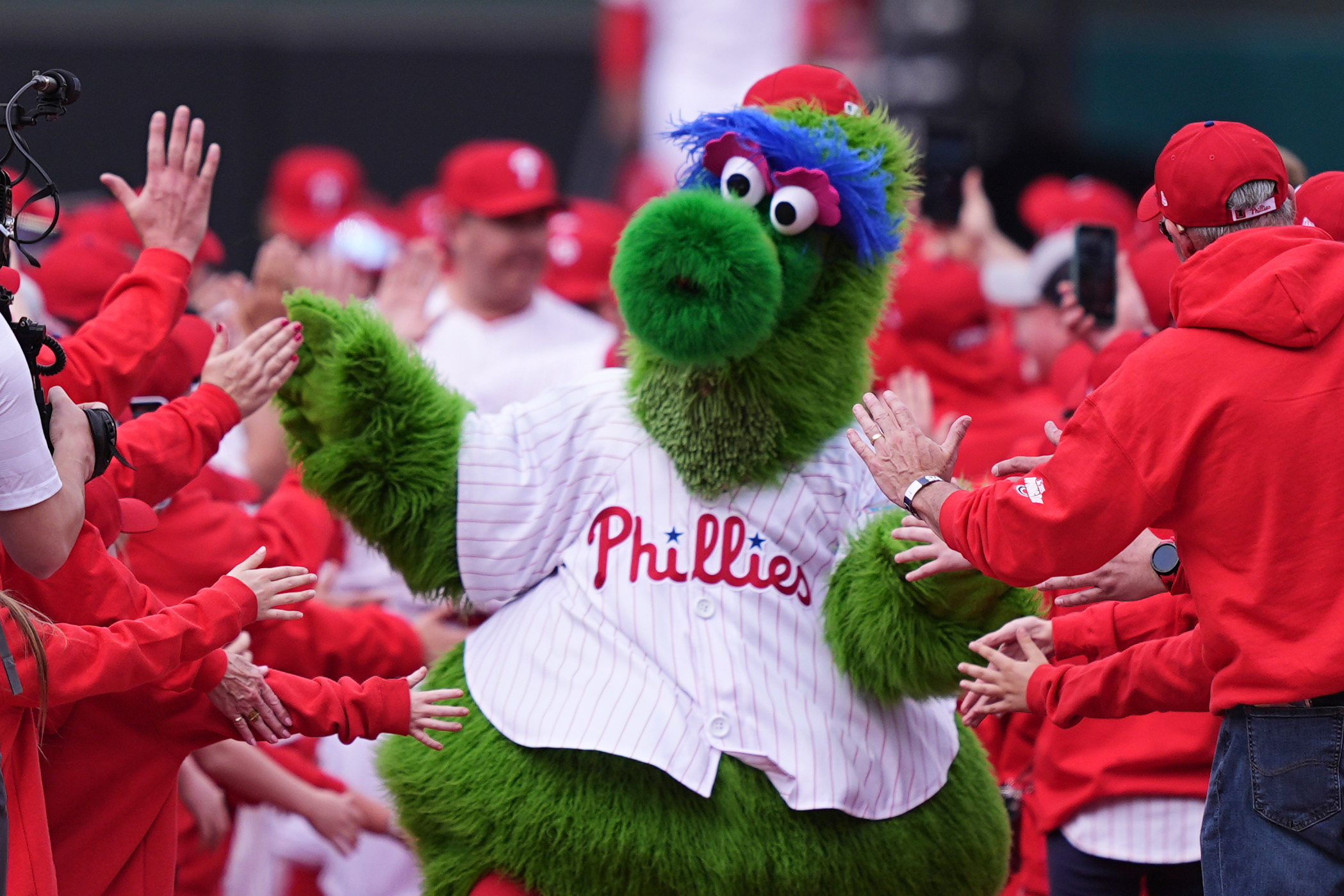 FILE - The Phillie Phanatic, the Philadelphia Phillies mascot, leads the team onto the field ahead for their home-opener baseball game against the Colorado Rockies, Monday, March 31, 2025, in Philadelphia. 