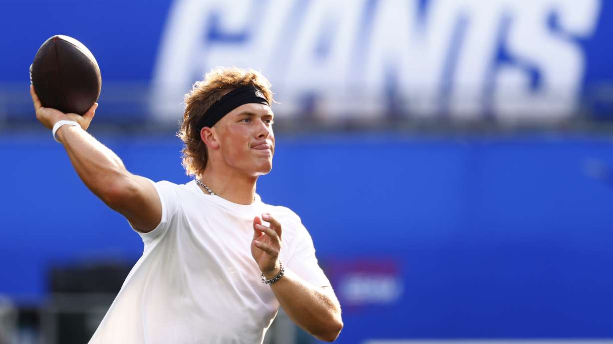 New York Giants quarterback Jaxson Dart warms up before a preseason NFL football game against the New York Jets in East Rutherford, N.J., Saturday, Aug. 16, 2025.