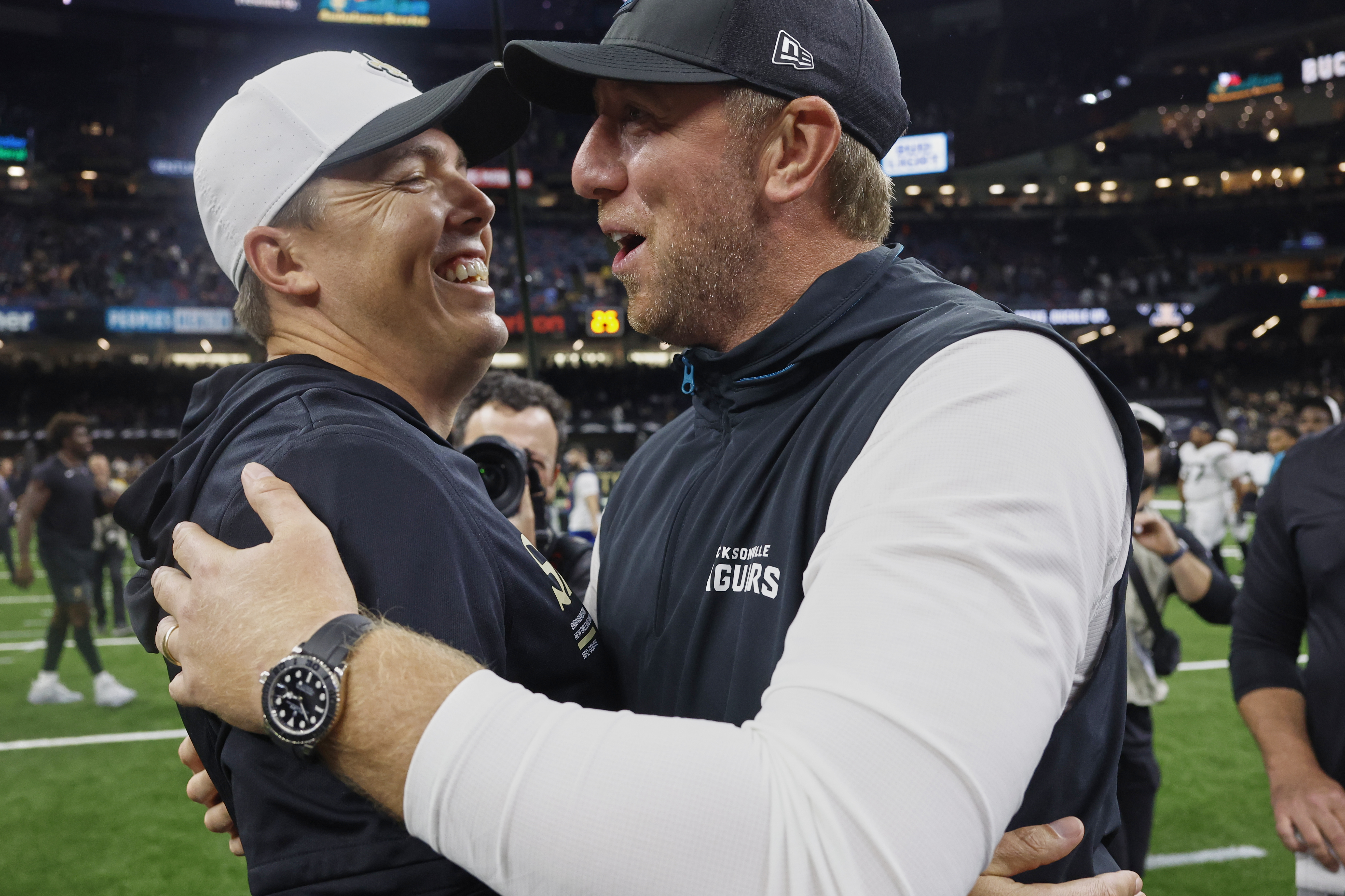 New Orleans Saints head coach Kellen Moore, left, greets Jacksonville Jaguars head coach Liam Coen after an NFL preseason football game in New Orleans, Sunday, Aug. 17, 2025. 