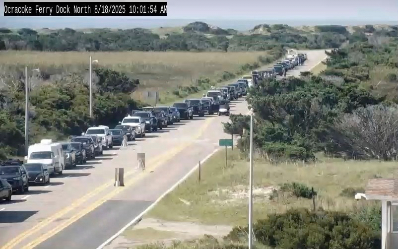 In this image taken from the North Carolina Department of Transportation camera, cars are lined up to evacuate via a ferry on the island of Hatteras Island, N.C., Monday, due to the expected impact of Hurricane Erin.