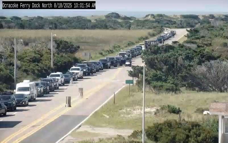 In this image taken from the North Carolina Department of Transportation camera, cars are lined up to evacuate via a ferry on the island of Hatteras Island, N.C., Monday, due to the expected impact of Hurricane Erin.