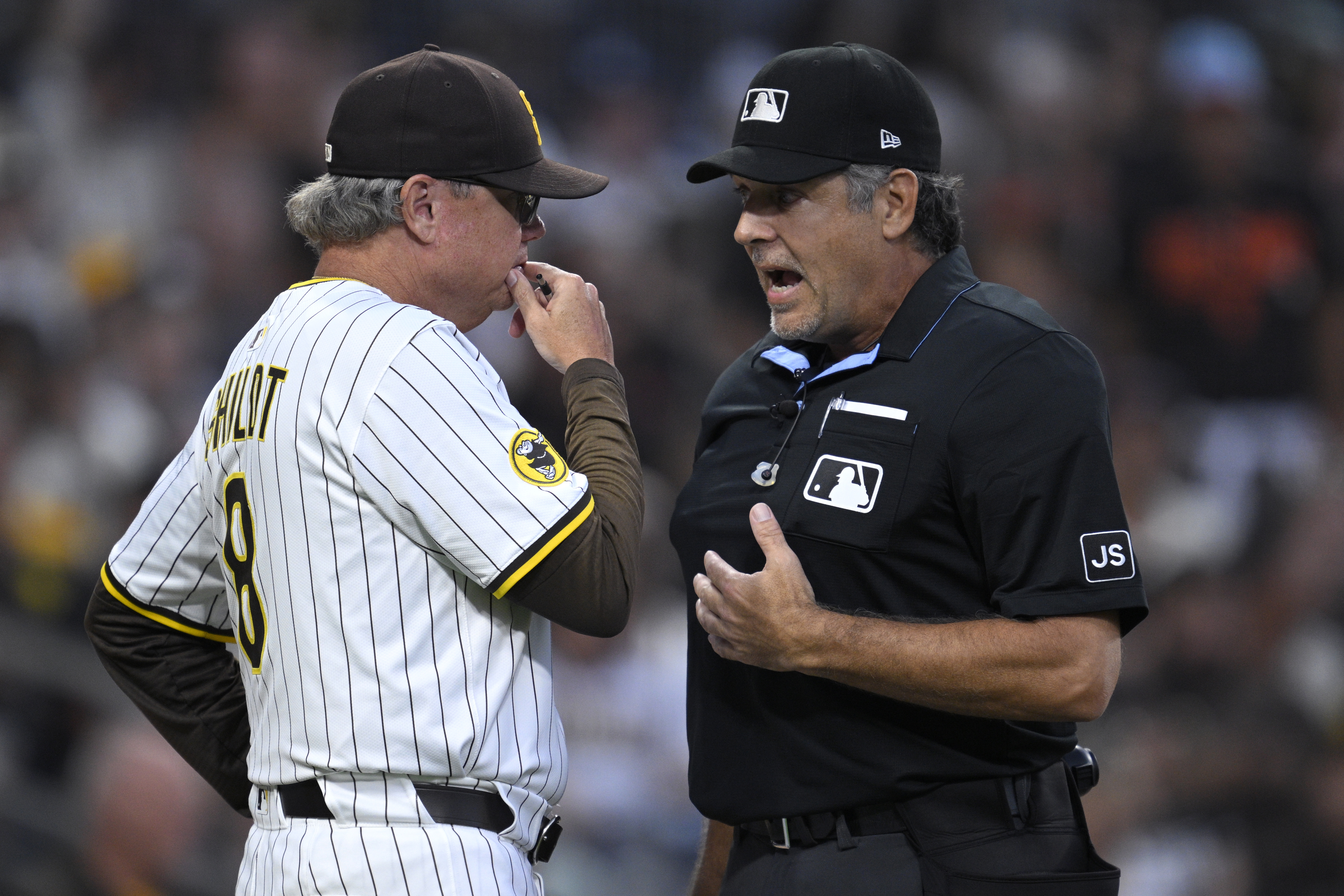 San Diego Padres manager Mike Shildt, left, talks to home plate umpire James Hoye, right, after being ejected during the second inning of a baseball game against the San Francisco Giants, Monday, Aug 18, 2025, in San Diego. 