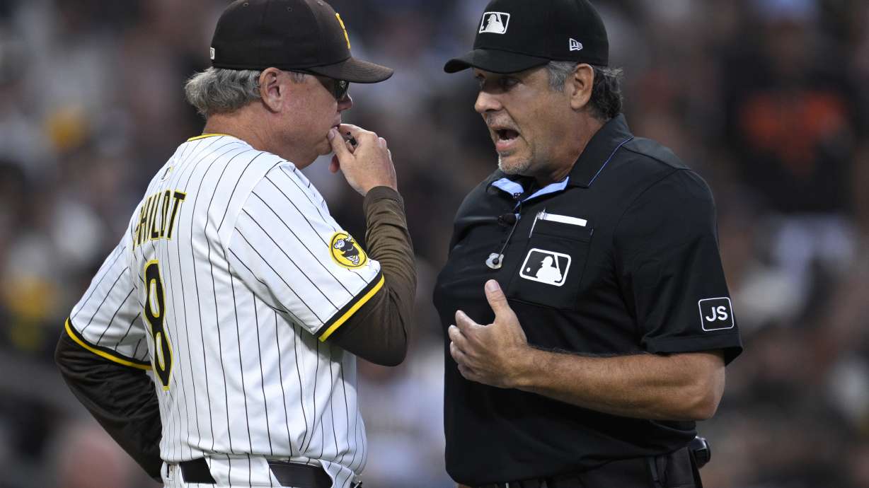 San Diego Padres manager Mike Shildt, left, talks to home plate umpire James Hoye, right, after being ejected during the second inning of a baseball game against the San Francisco Giants, Monday, Aug 18, 2025, in San Diego.