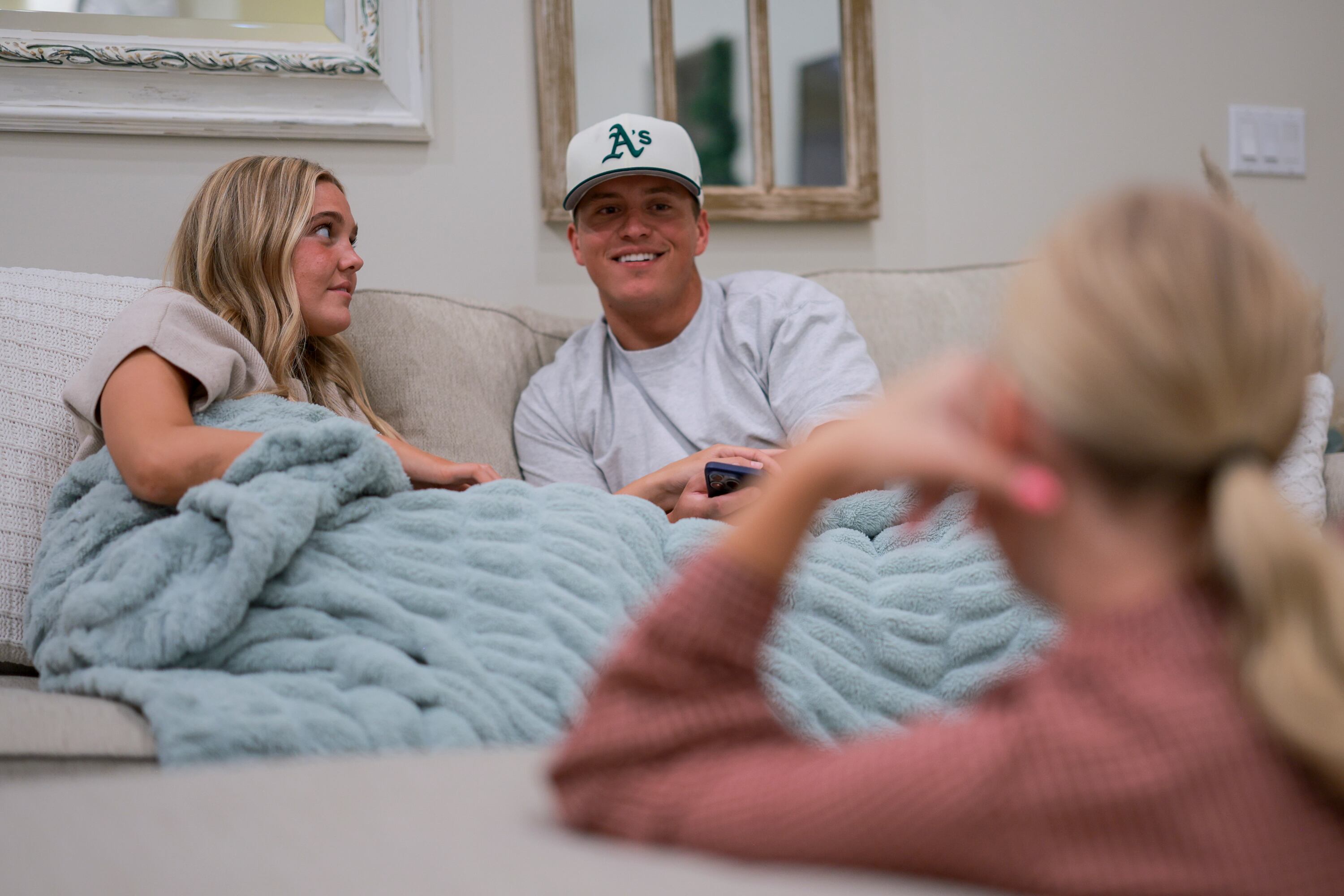 Azure Wilson, center, talks with Jenna Olson and his girlfriend, Megan Olson, left, in the living room of the Olson’s Layton home on Sunday.