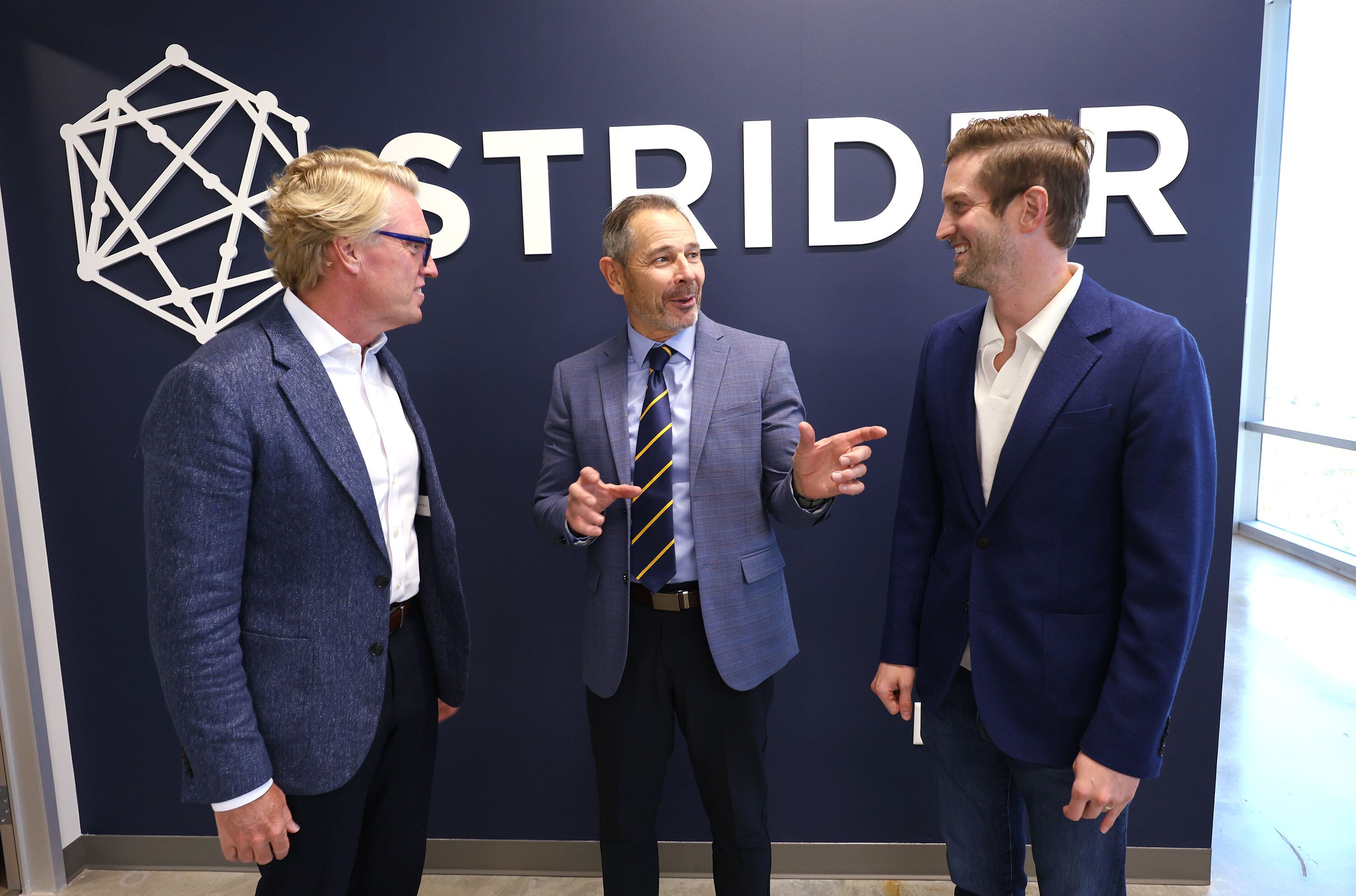 Sen. John Curtis, center, talks with Strider CEO Greg Levesque, right, and Strider General Counsel Robert Lamb prior to speaking at a town hall at Strider Technologies in South Jordan on Monday.