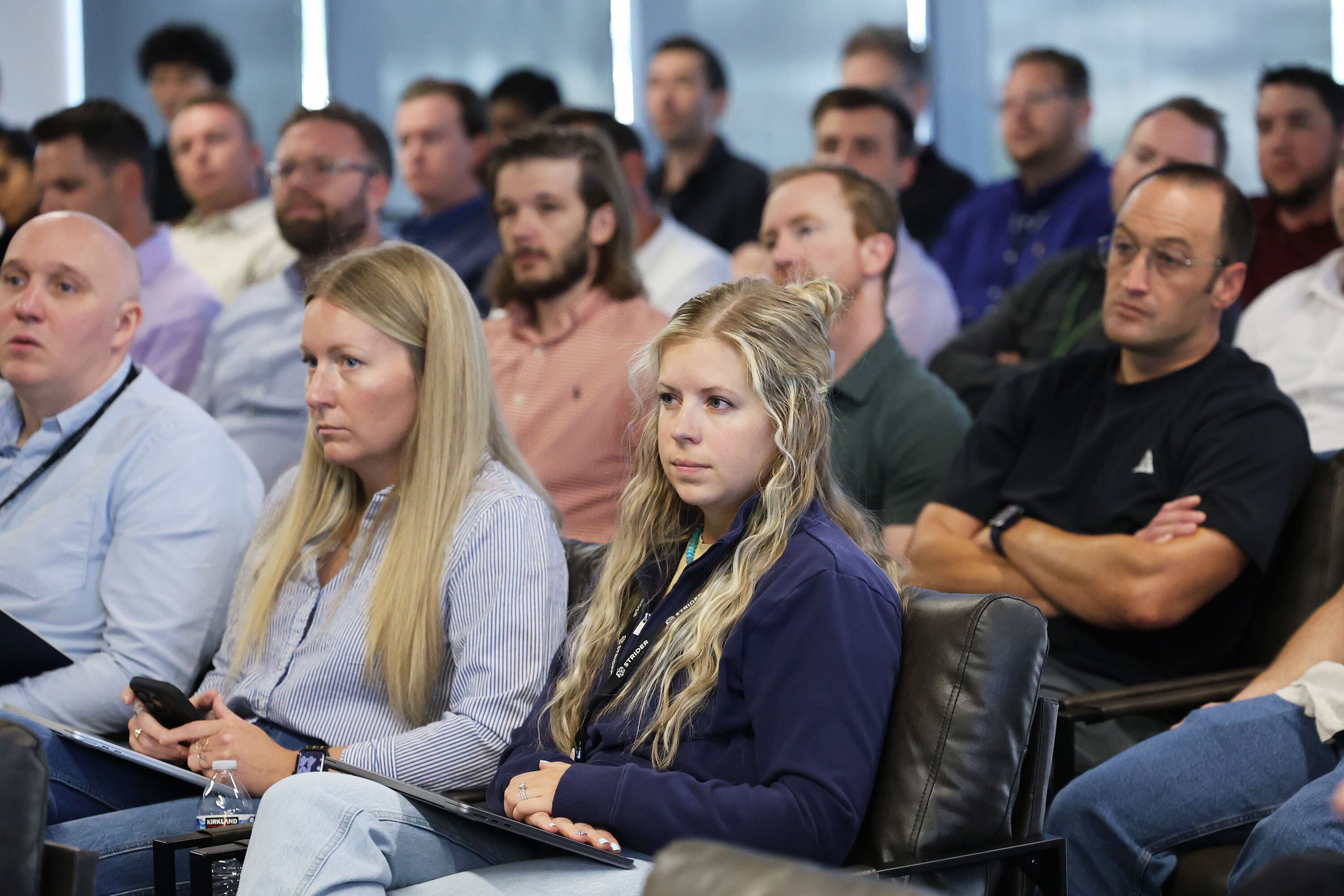 Attendees listen as Sen. John Curtis speaks during a town hall at Strider Technologies in South Jordan on Monday.