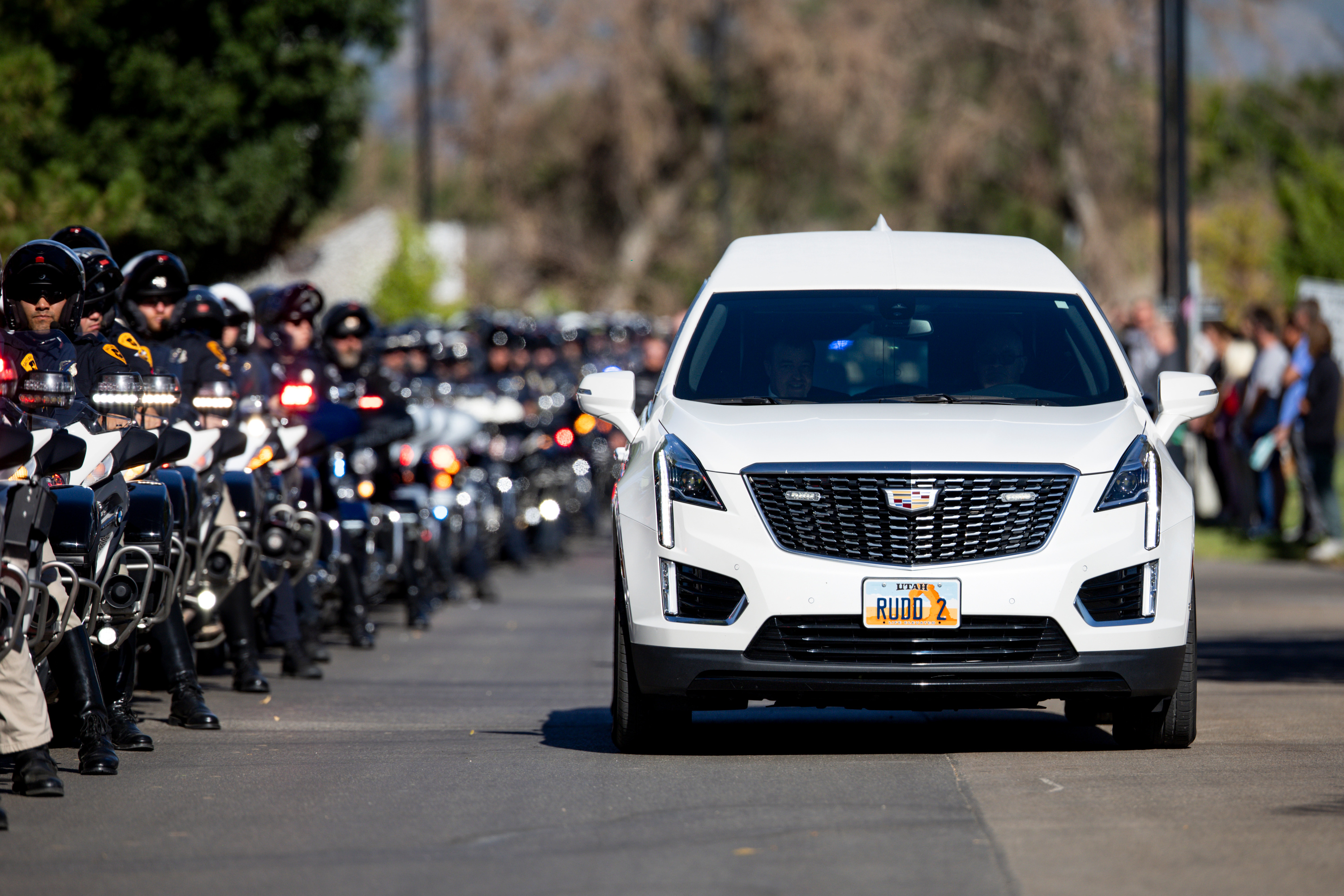 The hearses carrying the bodies of fallen Tremonton-Garland police officers, Sgt. Lee Sorensen and officer Eric Estrada, are escorted by police officers on motorcycles as they depart the Utah State Medical Examiner's Office in Taylorsville to Garland and Logan on Monday.