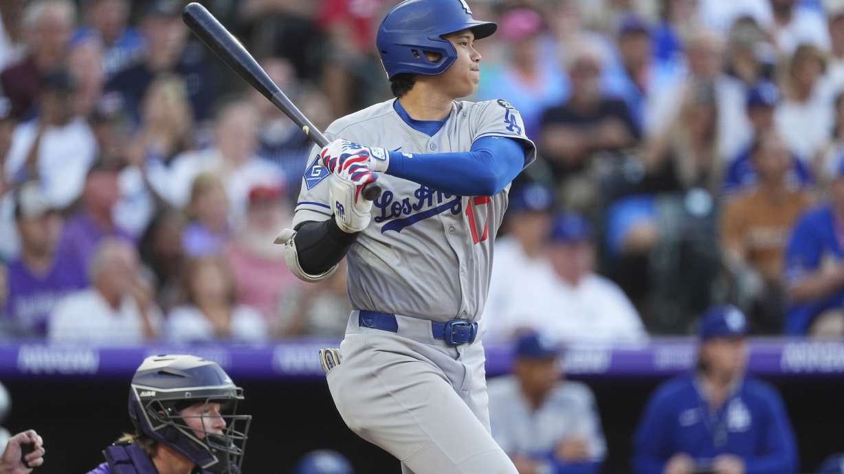 Los Angeles Dodgers' Shohei Ohtani follows the flight of his RBI single off Colorado Rockies starting pitcher Kyle Freeland in the second inning of a baseball game Monday, Aug. 18, 2025, in Denver.