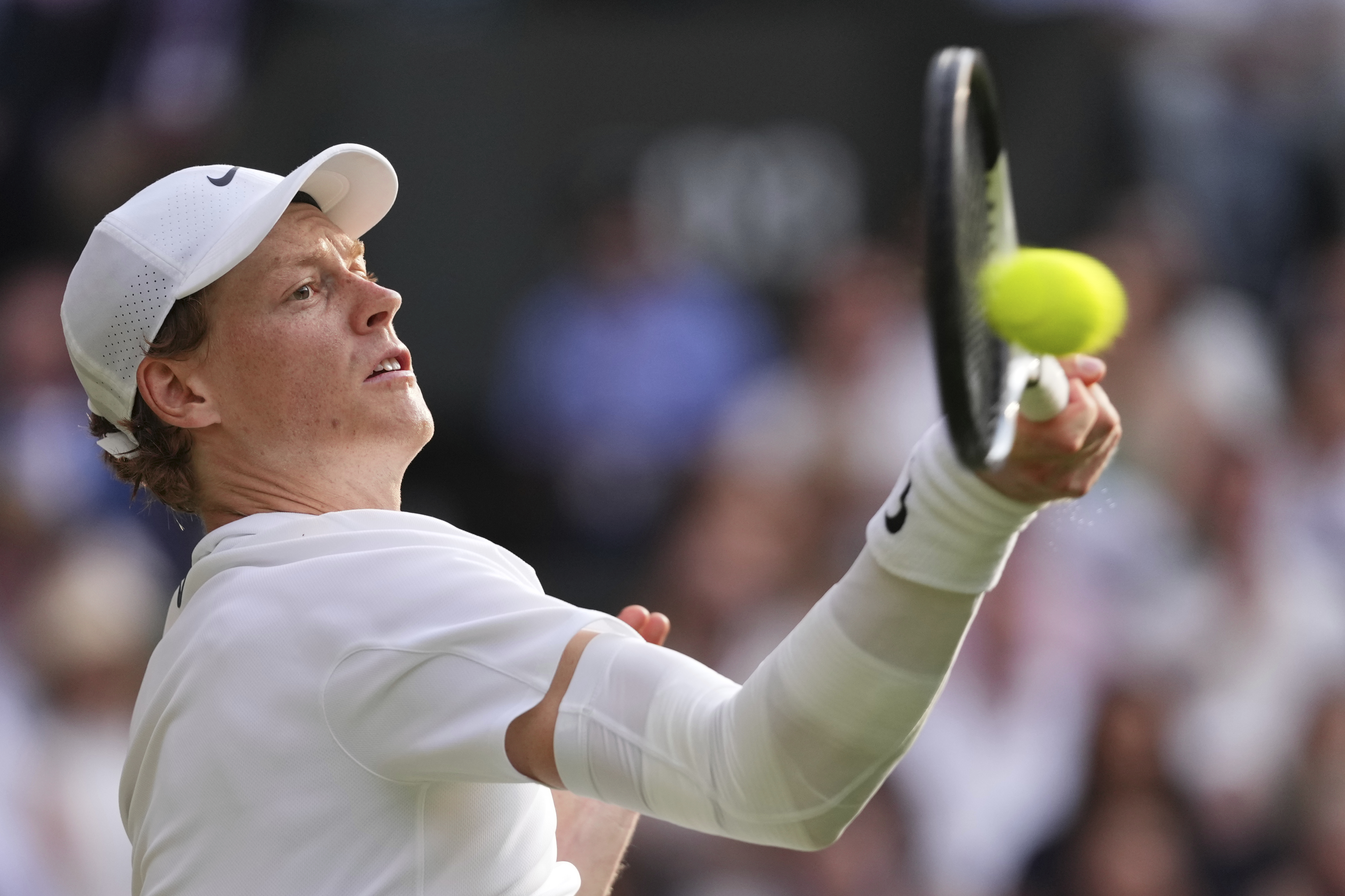 FILE - Jannik Sinner of Italy plays a return to Carlos Alcaraz of Spain during the men's singles final match at the Wimbledon Tennis Championships in London, Sunday, July 13, 2025.