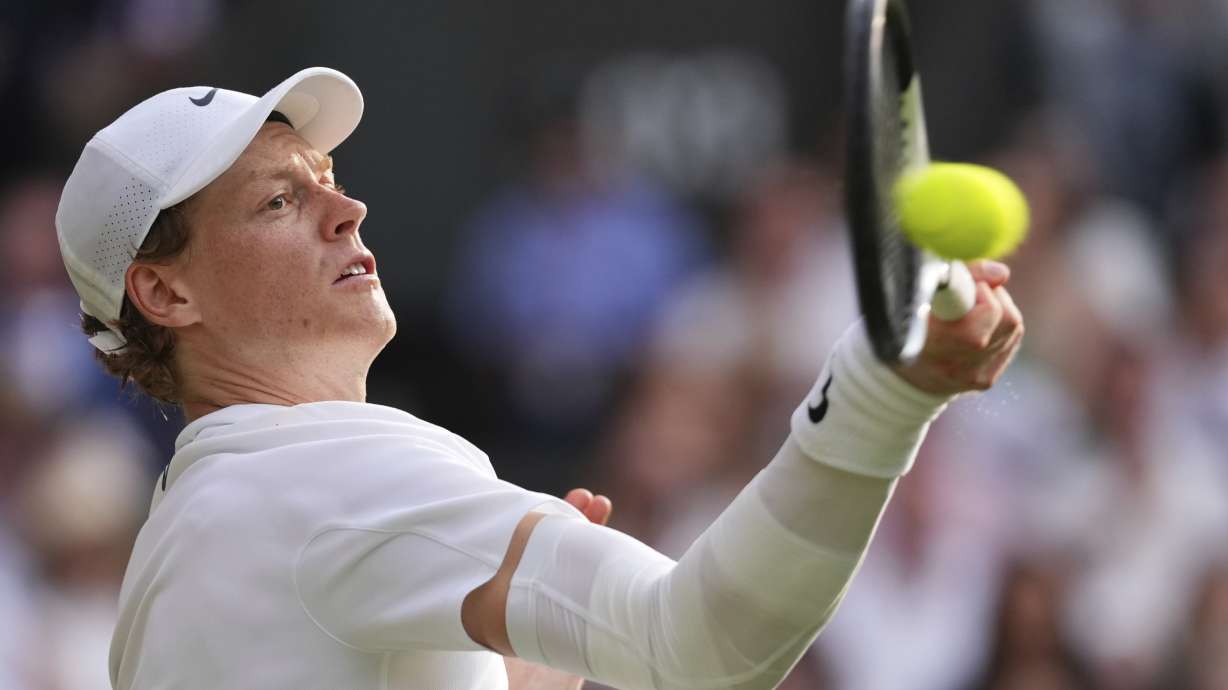 FILE - Jannik Sinner of Italy plays a return to Carlos Alcaraz of Spain during the men's singles final match at the Wimbledon Tennis Championships in London, Sunday, July 13, 2025.