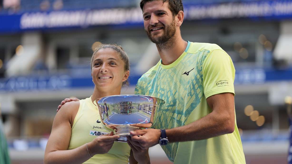 FILE - Sara Errani, of Italy, and Andrea Vavassori, of Italy, hold up the championship trophy after defeating Taylor Townsend, of the United States, and Donald Young, of the United States, in the mixed doubles final of the U.S. Open tennis championships, Thursday, Sept. 5, 2024, in New York.