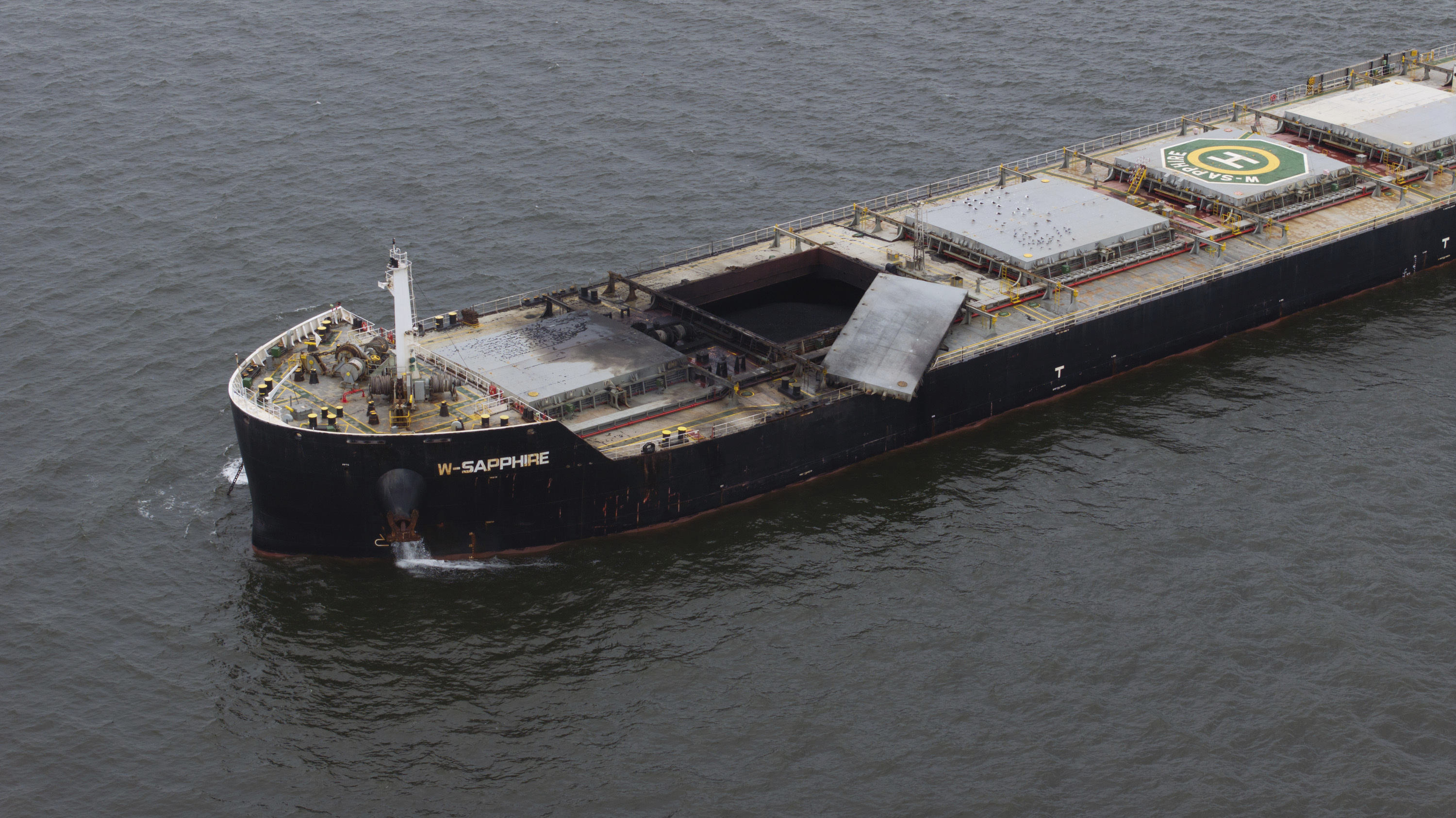 The W-Sapphire bulk carrier is seen anchored off Sandy Point, Md., the morning after an explosion occurred in one of its holds as it was leaving the Port of Baltimore, Tuesday. 
