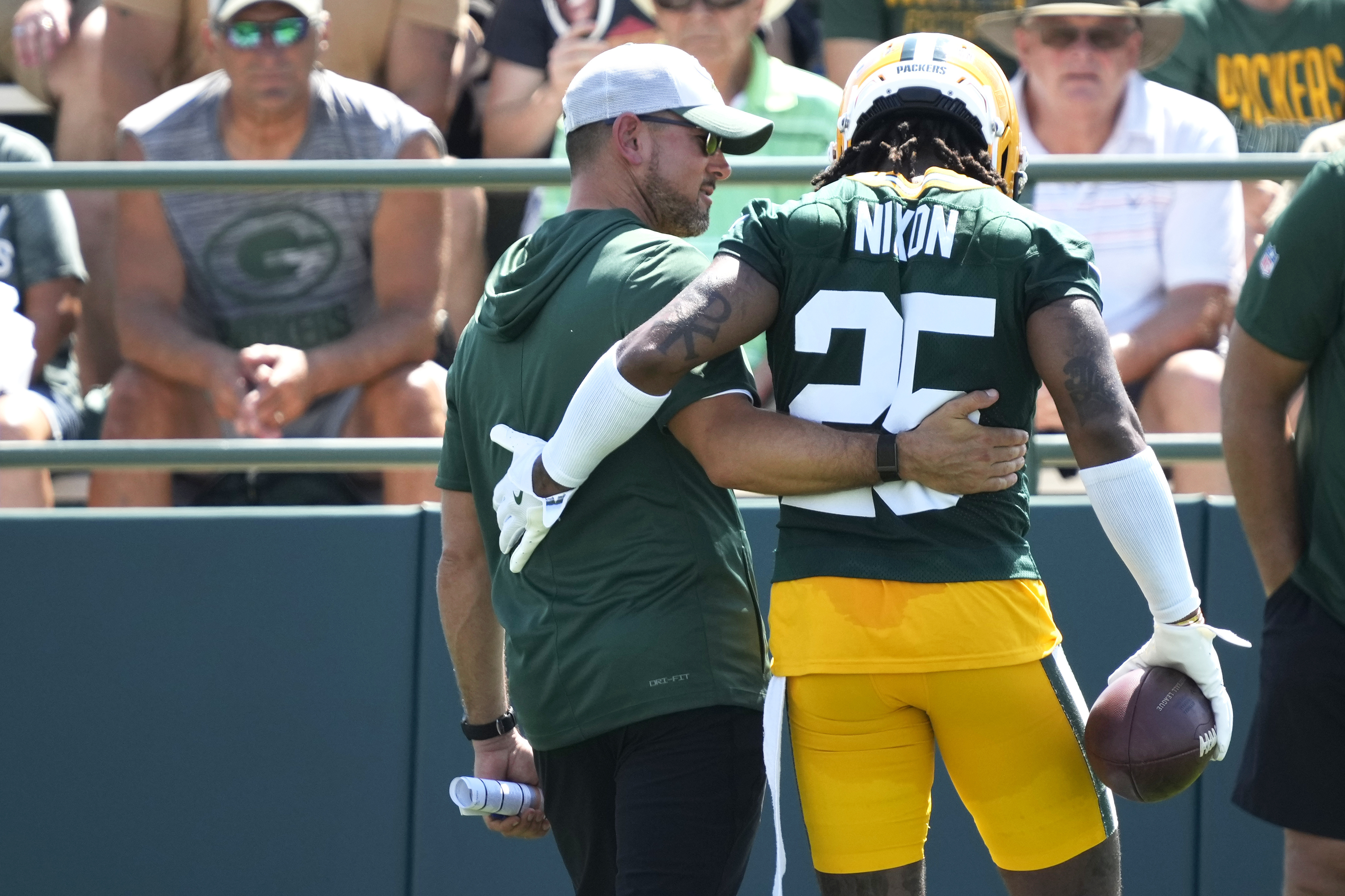 Green Bay Packers Head Coach Matt LaFleur, left, talks with Keisean Nixon (25) during an NFL football practice Sunday, July 27, 2025, in Green Bay, Wis.