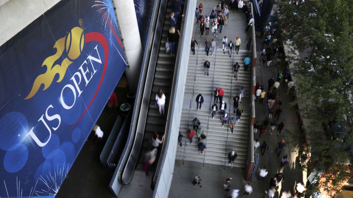 FILE - Tennis fans move in and out of Arthur Ashe Stadium during the fourth round of the U.S. Open tennis tournament in New York, Sept. 3, 2017. The U.S. Open, the year's last Grand Slam tennis tournament, starts Monday.