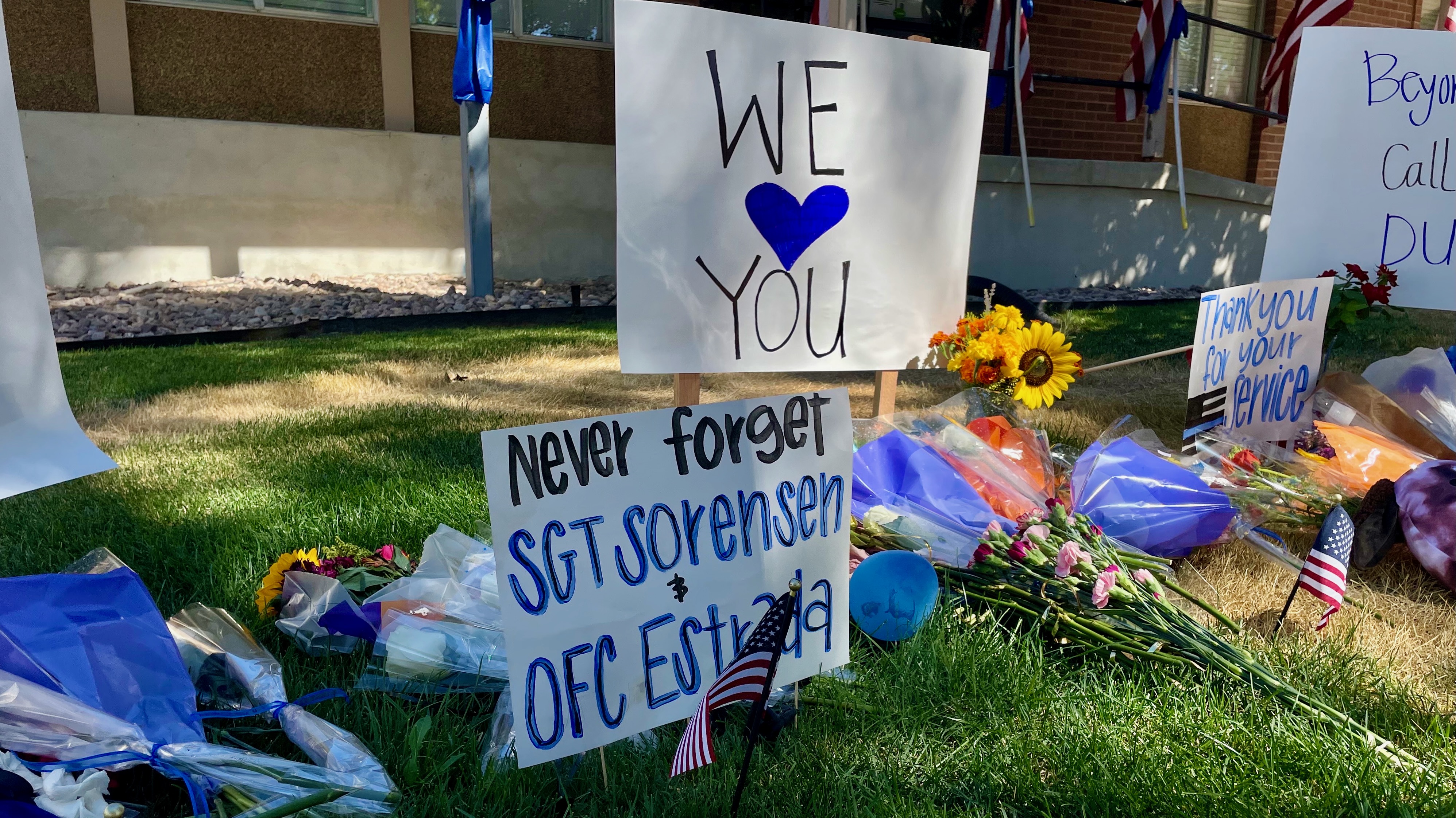 Signs remembering Sgt. Lee Sorensen and officer Eric Estrada are posted outside the Tremonton-Garland Police Department on Tuesday, following their deaths at the hands of a gunman.