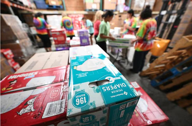 Student volunteers from Stillwater Academy label, rewrap and sort diapers at the Utah Diaper Bank in Murray, July 21, 2023. 