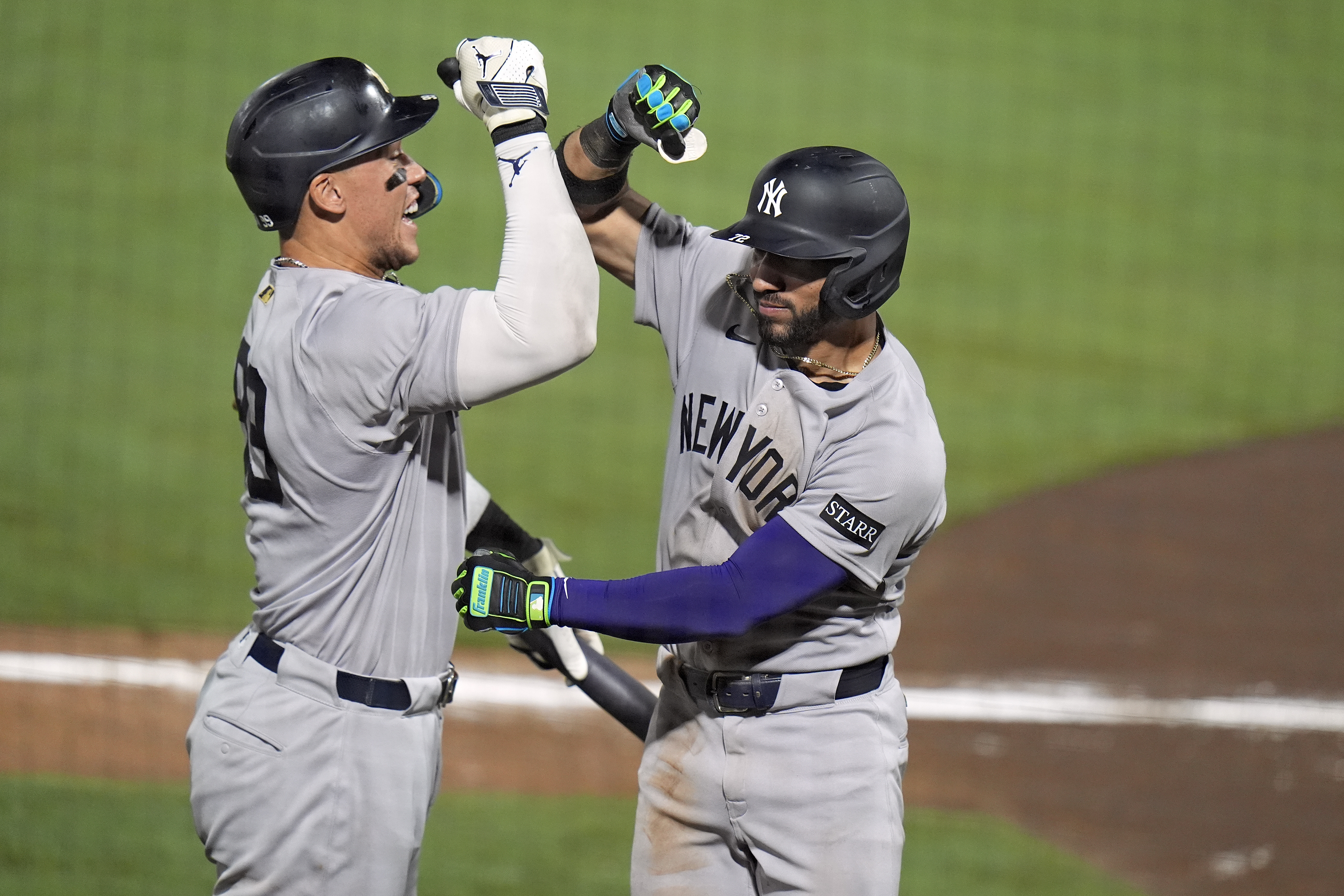 New York Yankees' José Caballero, right, celebrates his home run off Tampa Bay Rays pitcher Mason Montgomery with Aaron Judge during the ninth inning of a baseball game Wednesday, Aug. 20, 2025, in Tampa, Fla. 