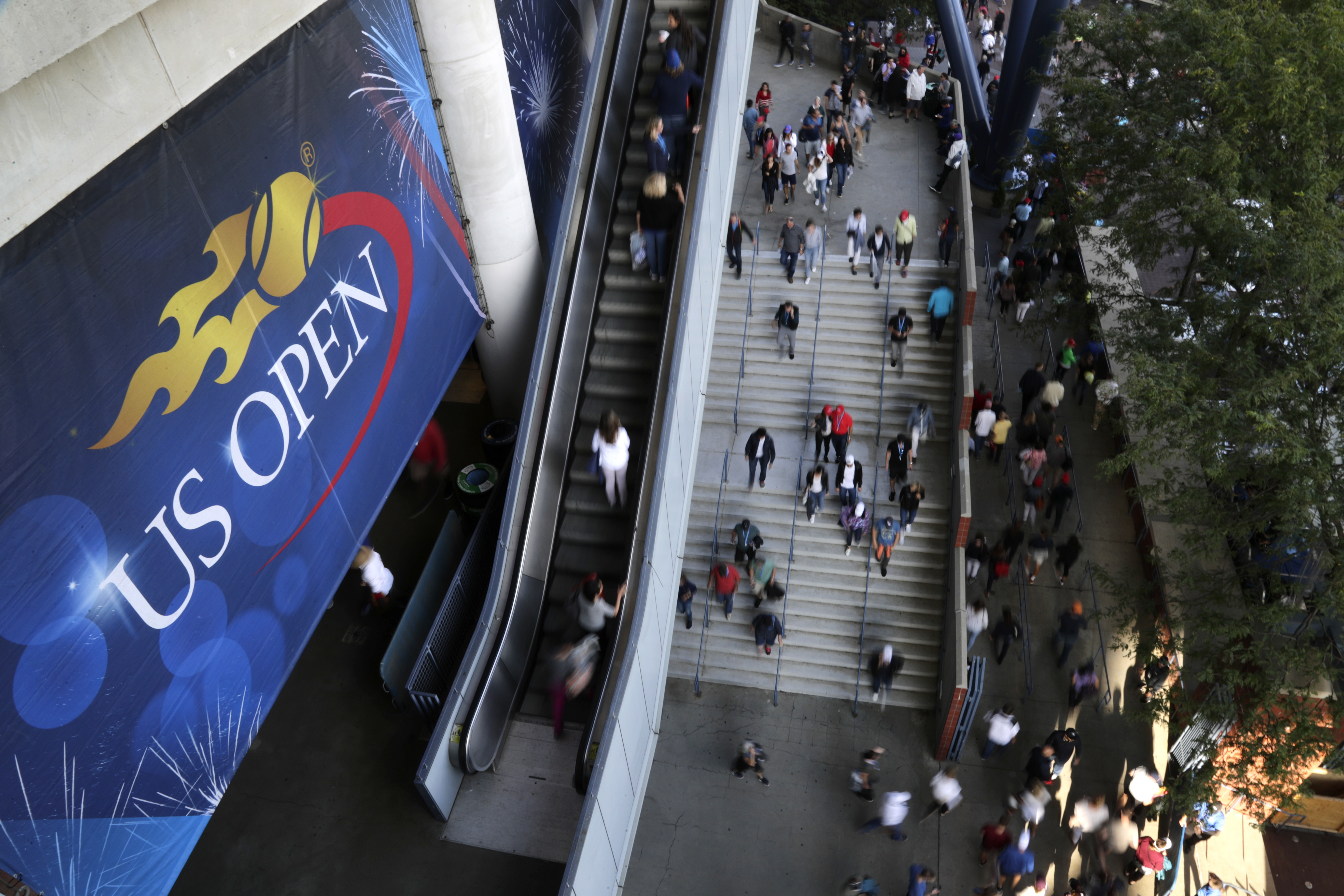 FILE - Tennis fans move in and out of Arthur Ashe Stadium during the fourth round of the U.S. Open tennis tournament in New York, Sept. 3, 2017. The U.S. Open, the year's last Grand Slam tennis tournament, starts Monday.