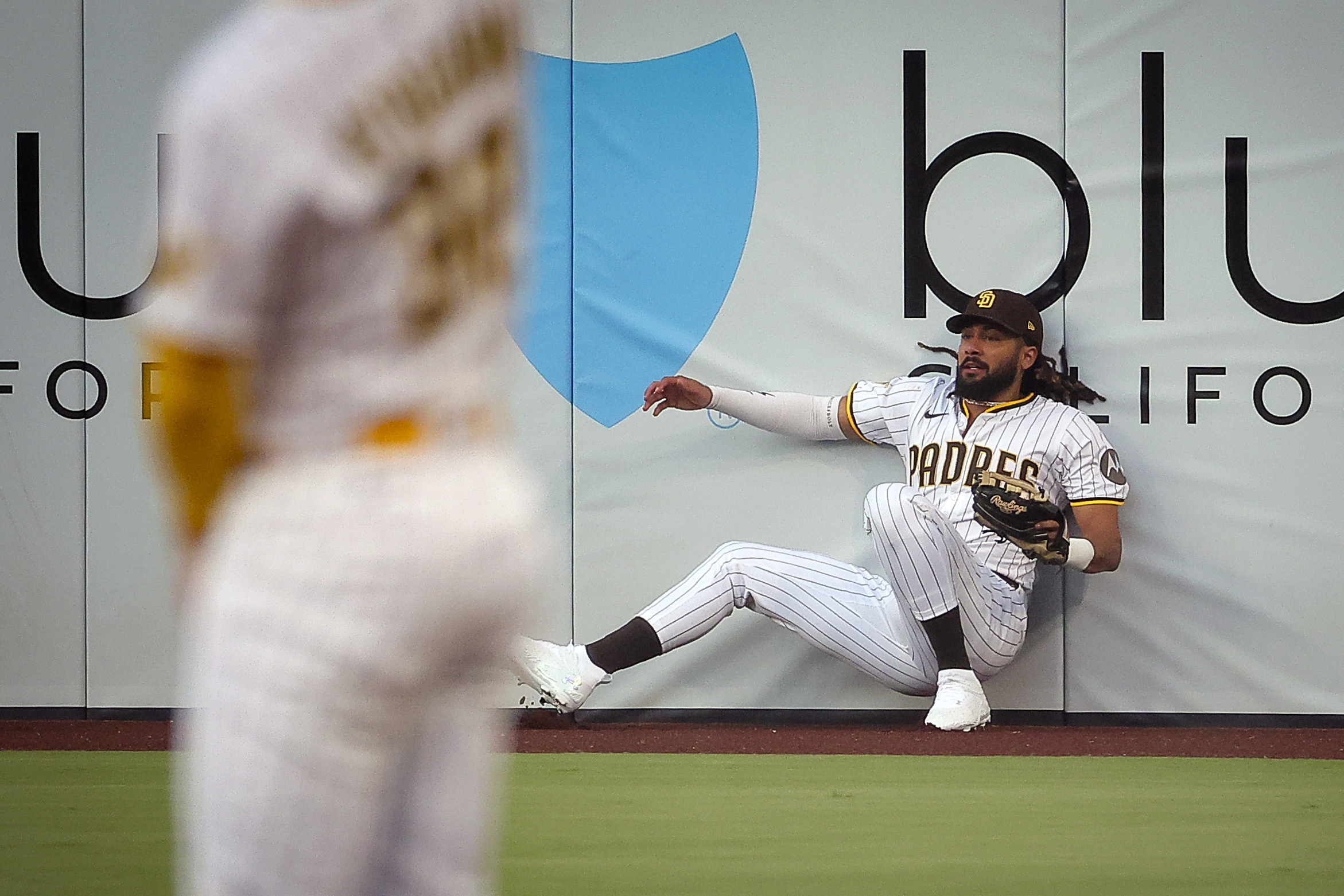 San Diego Padres right fielder Fernando Tatis Jr. makes a catch at the wall during the first inning against the San Francisco Giants on Wednesday, Aug. 20, 2025, in San Diego. 