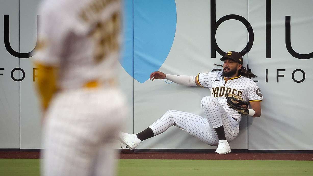 San Diego Padres right fielder Fernando Tatis Jr. makes a catch at the wall during the first inning against the San Francisco Giants on Wednesday, Aug. 20, 2025, in San Diego.