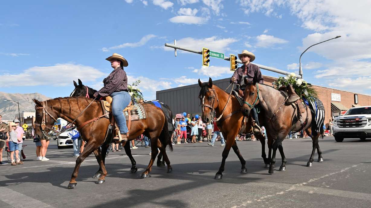 Honor riders pass in memory of slain Tremonton-Garland police officers Lee Sorensen and Eric Estrada for the Box Elder Fair Parade Wednesday. Prosecutors say they'll seek the death penalty for the man charged with killing them.