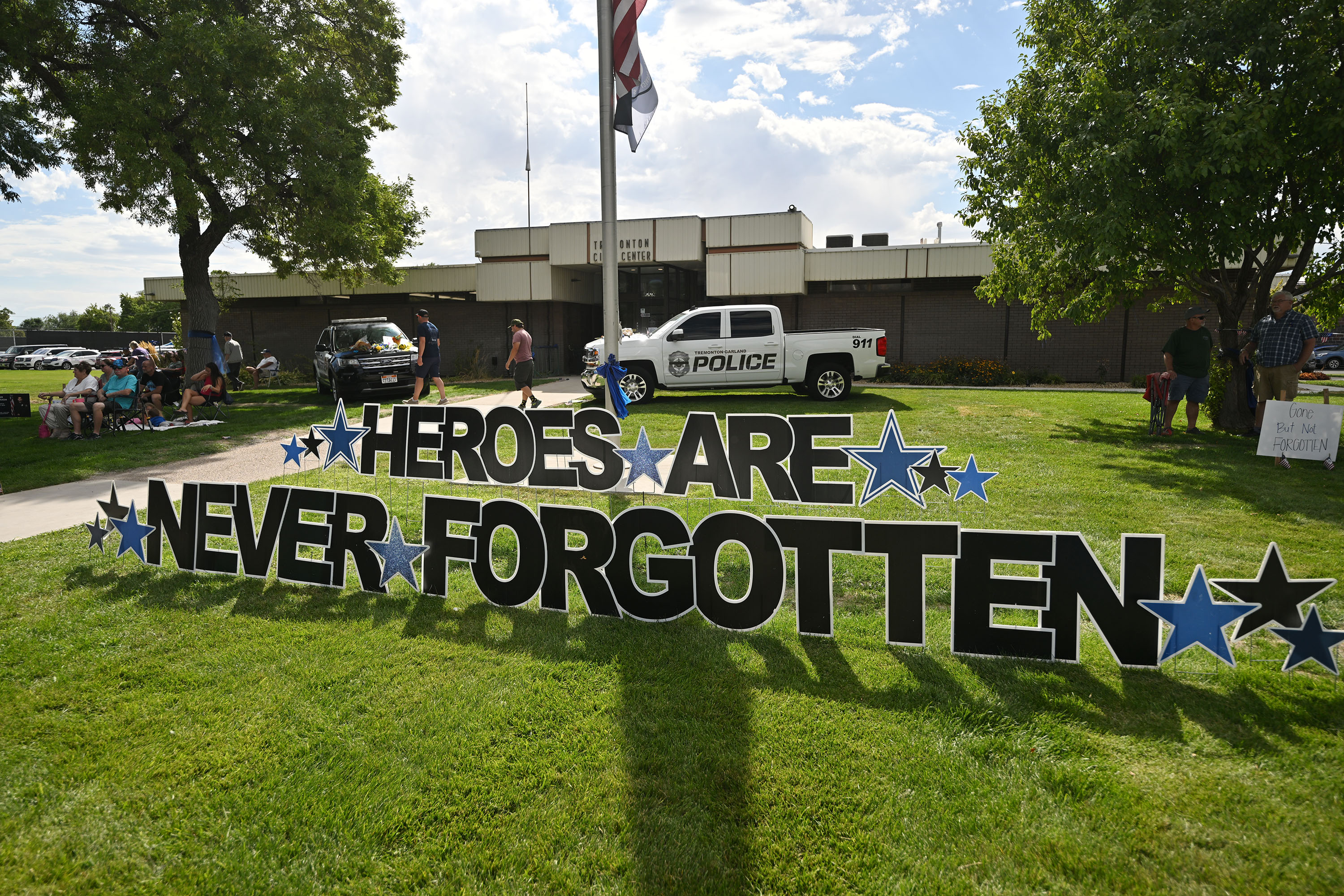 Tremonton-Garland police vehicles sit with flowers and signs on them as thousands gather in Tremonton for the Box Elder Fair Parade Wednesday. They honored the memory of Sgt. Lee Sorensen and officer Eric Estrada, who were killed in the line of duty.