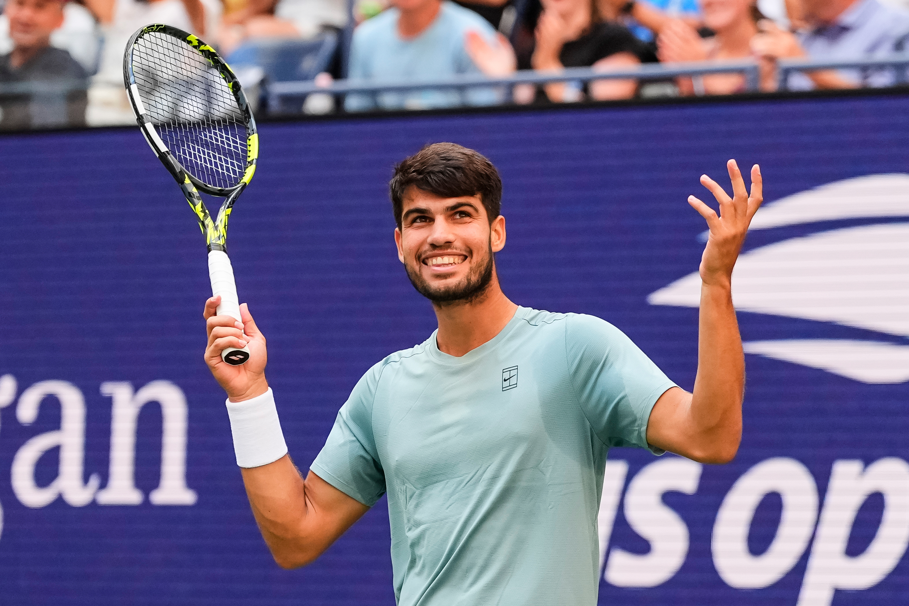 Carlos Alcaraz, of Spain, gestures to fans during a mixed doubles match at the U.S. Open tennis championships, Tuesday, Aug. 19, 2025, in New York.