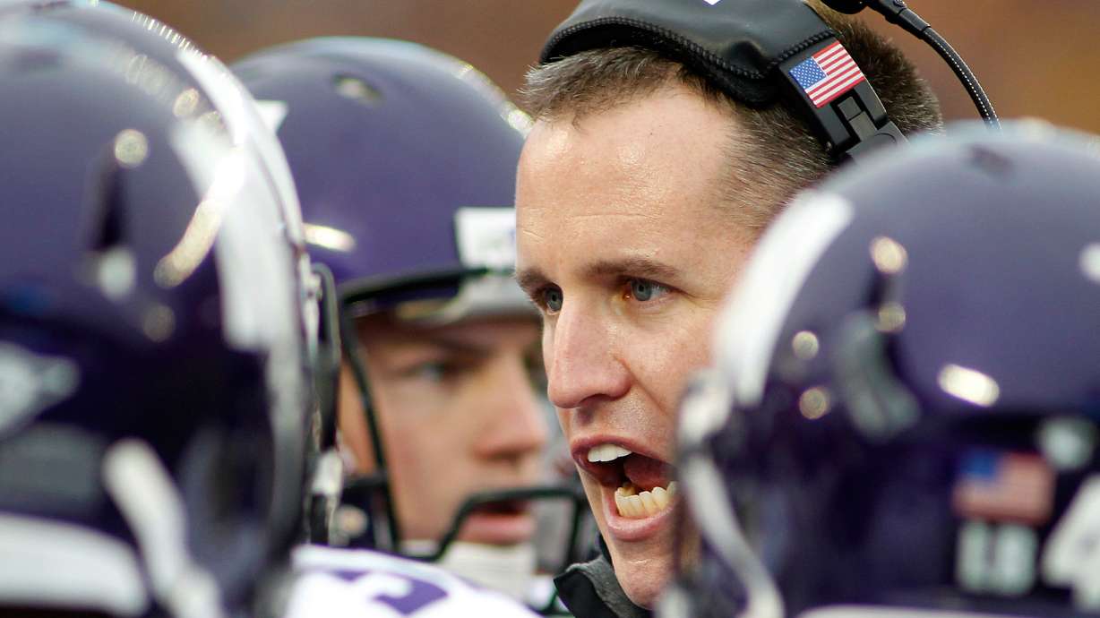 FILE - Northwestern head coach Pat Fitzpatrick talks to his players in the first half of a NCAA college football game against Minnesota in Minneapolis, Oct. 13, 2012.