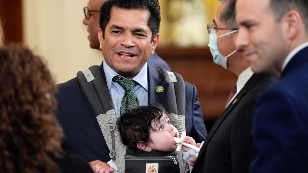 Rep. Jimmy Gomez, D-Calif., arrives with his son Hodge, for an event in the East Room of the White House in Washington on March 23, 2023. Members of the congressional Dad Caucus are pushing for a legislative package that would lift tariffs on items such as diapers, formula, strollers and car seats.