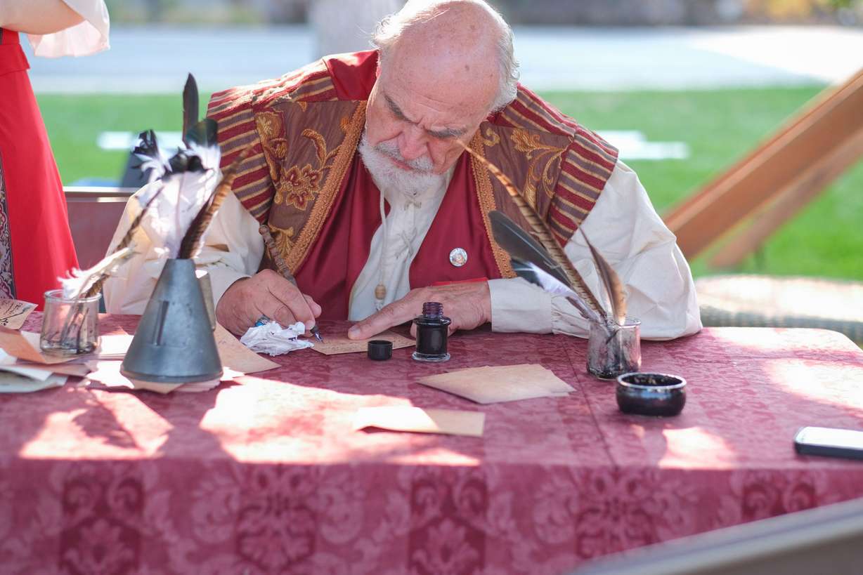 King Henry writes out a quest at the the Utah Renaissance Faire. The 13th annual festival will be this weekend at the Mt. Nebo Botanical Farm in Mona.
