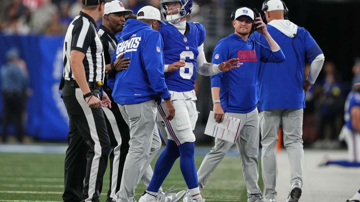 New York Giants quarterback Jaxson Dart (6) is walked off the field after being tackled by the New England Patriots during the first quarter of an NFL football game, Thursday, Aug. 21, 2025, in East Rutherford, N.J.